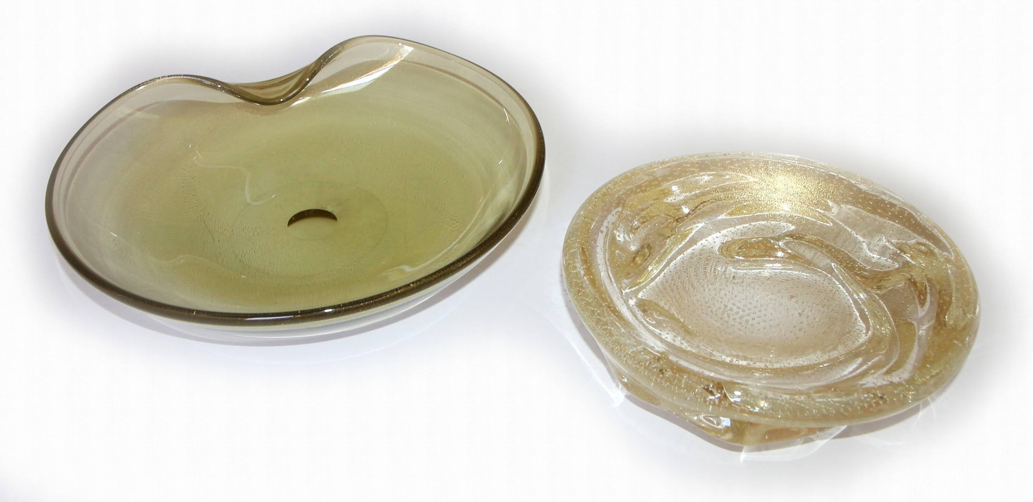 Two large Murano Italian handblown glass bowls. A clam shape bowl with gold inclusions and yellow/olive hue measure: 10" x 11.75", the other bowl in organic form with gold inclusion and controlled bubbles 9" diameter.