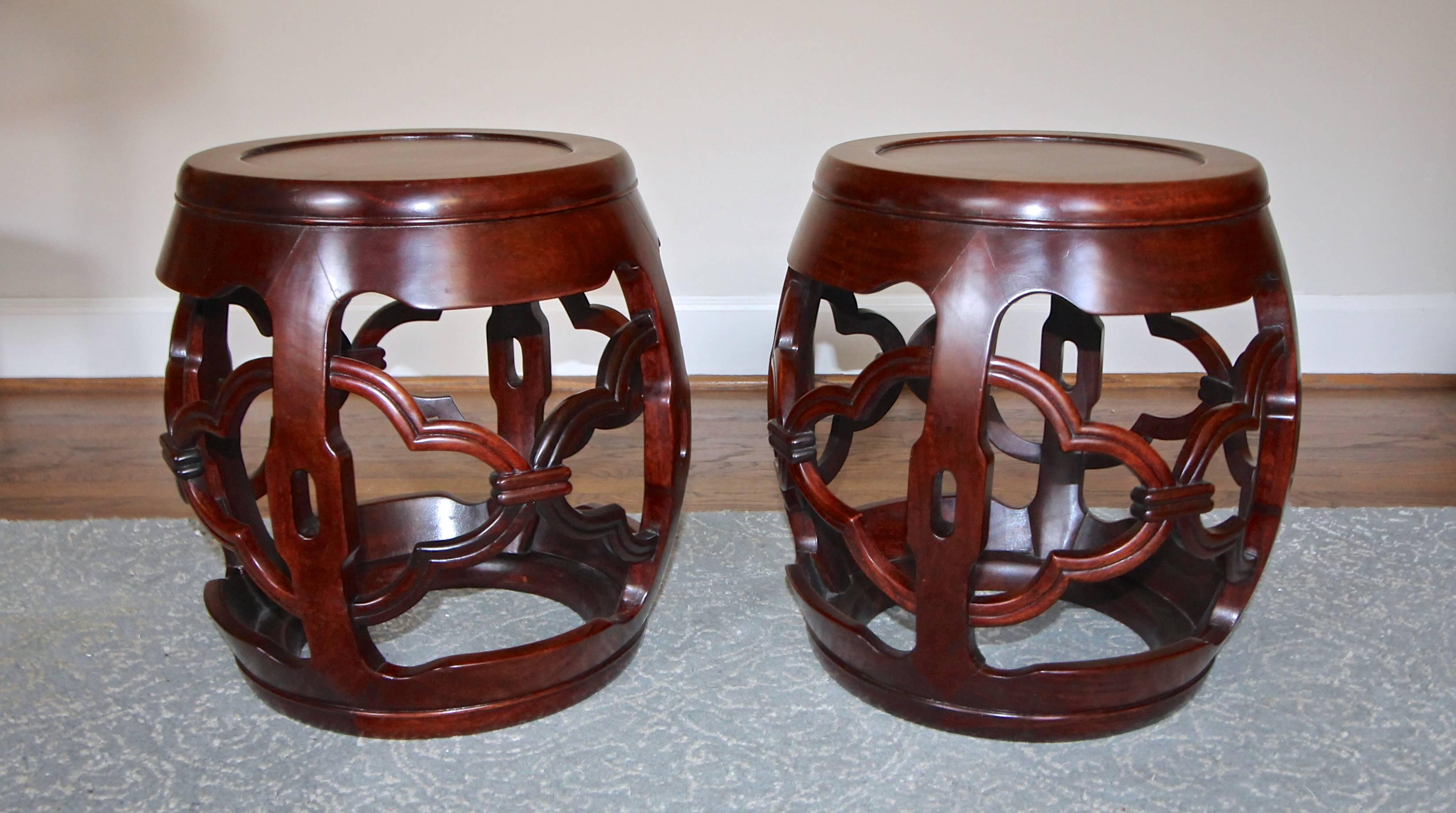 Pair of Chinese nicely carved hardwood garden stools. Each with carved and pierced decoration to the four supports and bases.