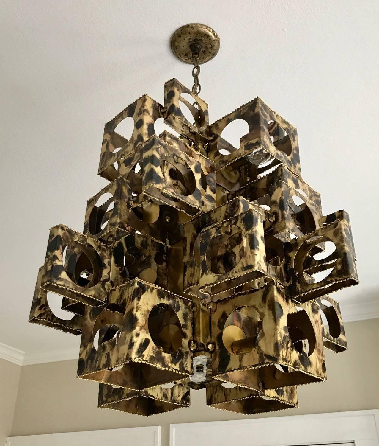 Large and rare cubist form brass chandelier constructed of various sizes and shapes of brass torch cut boxes by Tom Greene for the Feldman Company, Los Angeles. This is a hard to find and most desirable of the handcrafted chandeliers in the