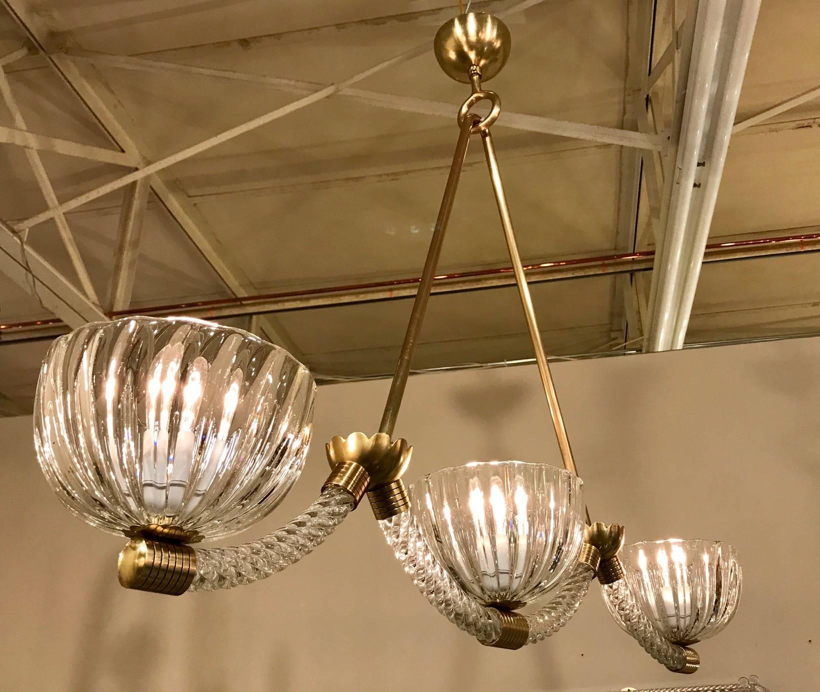 Barovier Murano glass three-light chandelier or pendant light fixture constructed from twisted ropes of clear glass and ribbed glass shades. Brass fittings feature a classic Barovier incised line motif. Newly wired for US, this light fixture uses