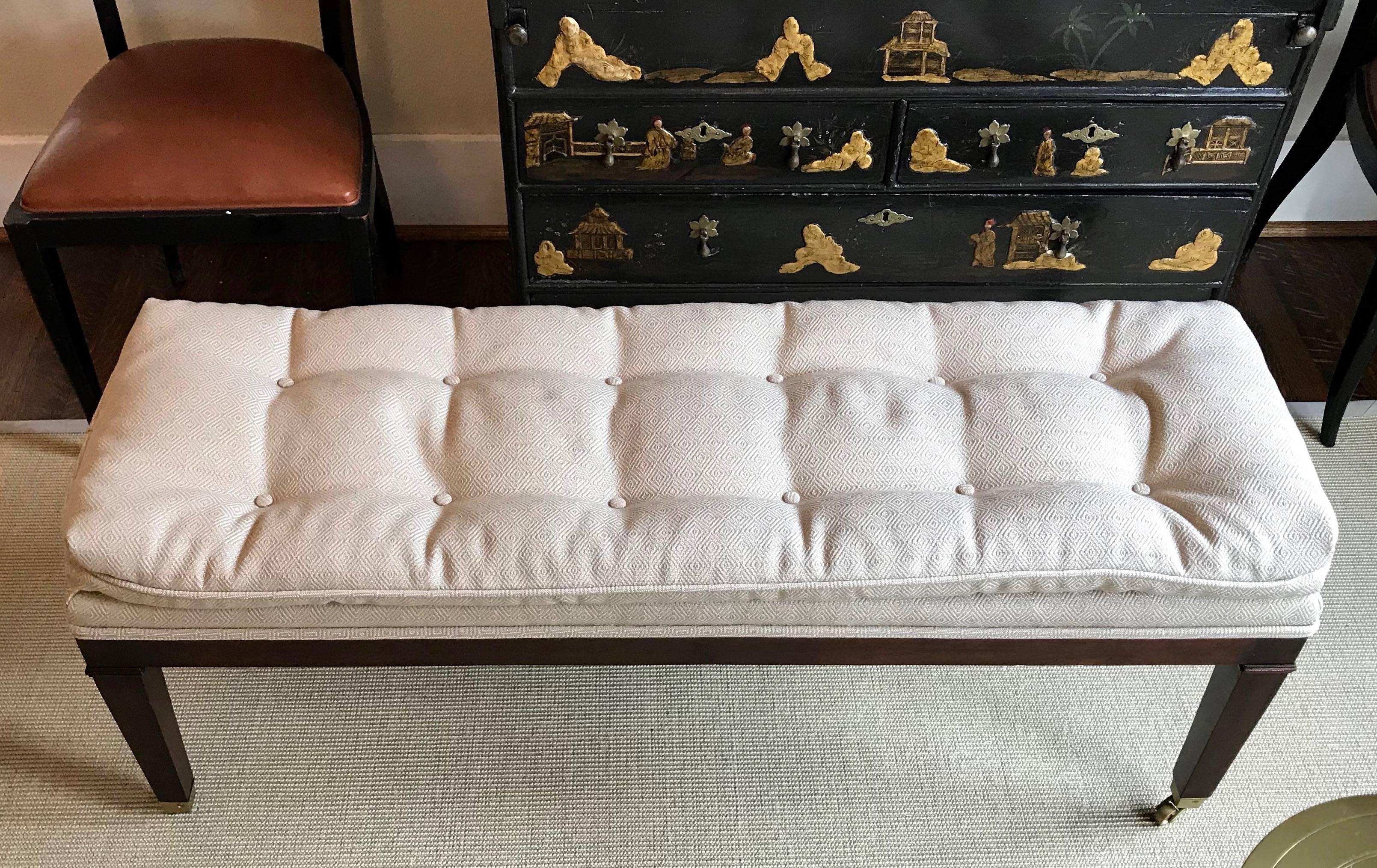 Long upholstered solid mahogany wood bench with brass casters and wheels. Perfect scale for foot of a king or queen size bed or entry or hallway. Very clean and handsome design that can move between traditional and transitional spaces. Frame is in