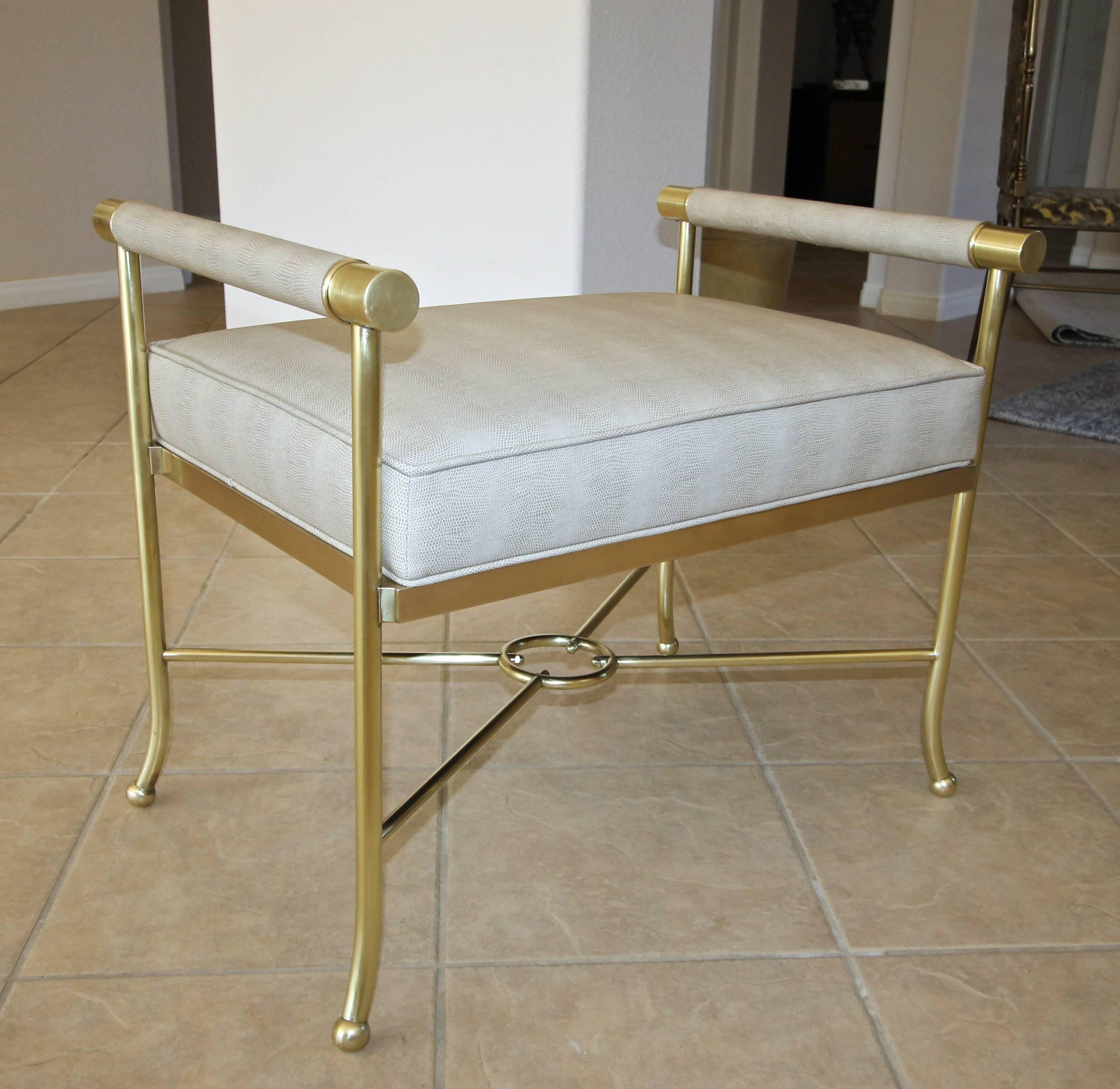 Solid brass X-base bench newly covered in taupe and cream tonal faux lizard upholstery in the style of Tommi Parzinger.
