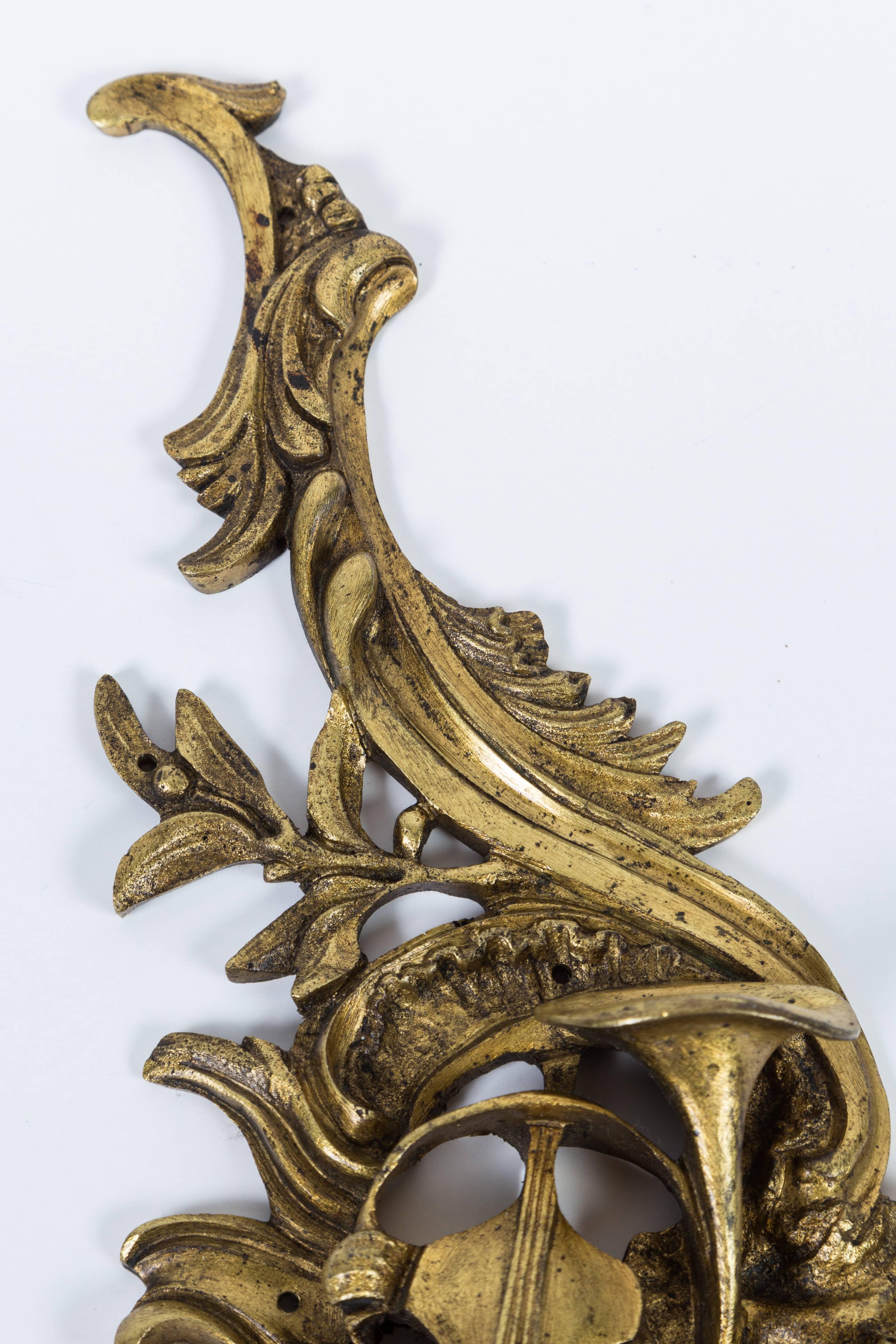 Heavy, ornate brass applique depicting musical instruments; originally used to decorate a piece of furniture, but will make a fascinating wall decoration.