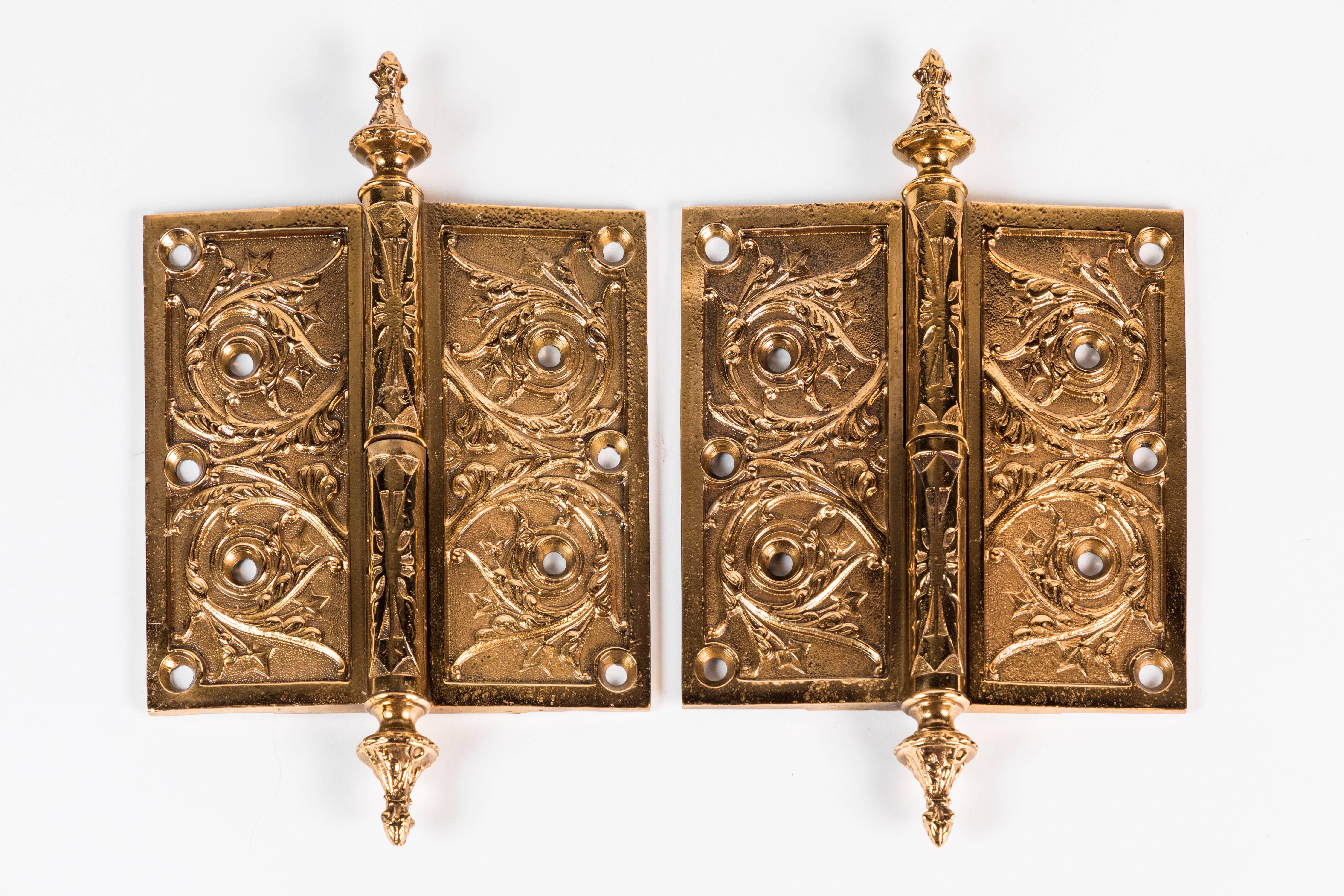 Two elaborate Victorian cast brass hinges; both left handed.