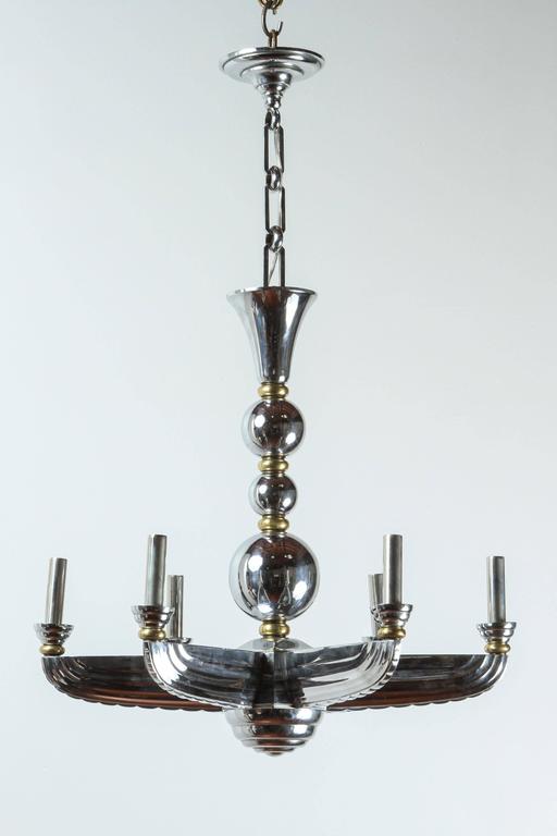 The photo shows six arms--this listing is for a chandelier with five arms.  French brass and chrome Art Deco chandelier with nickel candle covers. 