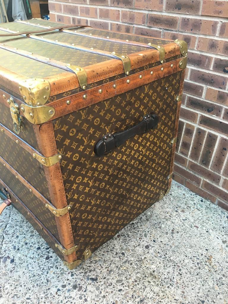 Stunning Louis Vuitton monogram steamer trunk in excellent condition. Monogram canvas exterior trimmed with wood, lozine, and brass hardware. Front triple latch closure opens to a beige canvas lined interior that holds multiple storage trays with