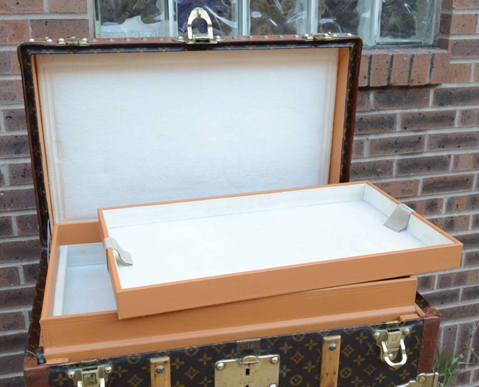 BREATHTAKING Louis Vuitton antique shoebox wardrobe trunk in impeccable condition.  Signature Louis Vuitton monogram canvas exterior trimmed with wood paneling, lozine edges, and brass hardware.  Leather belt included. Top and side latches open to