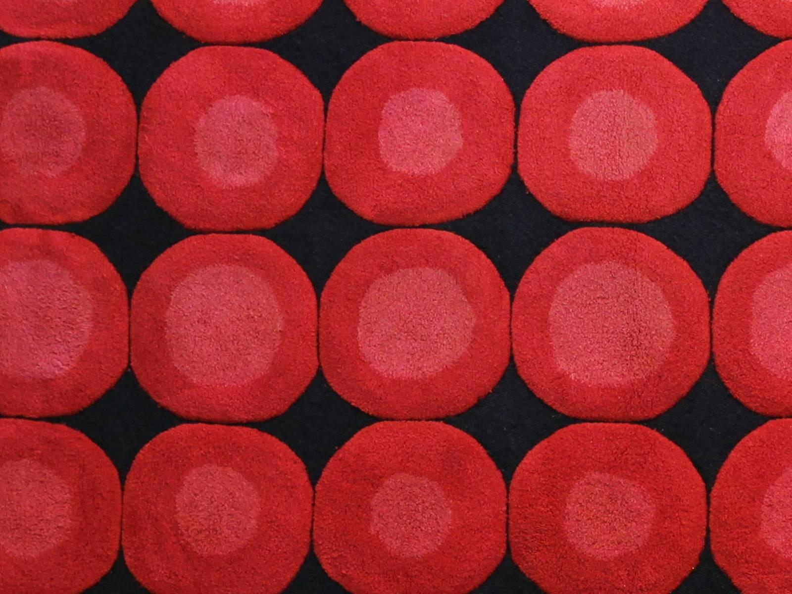 Rug in wool decorated with red circles on a black background, 1970 period.