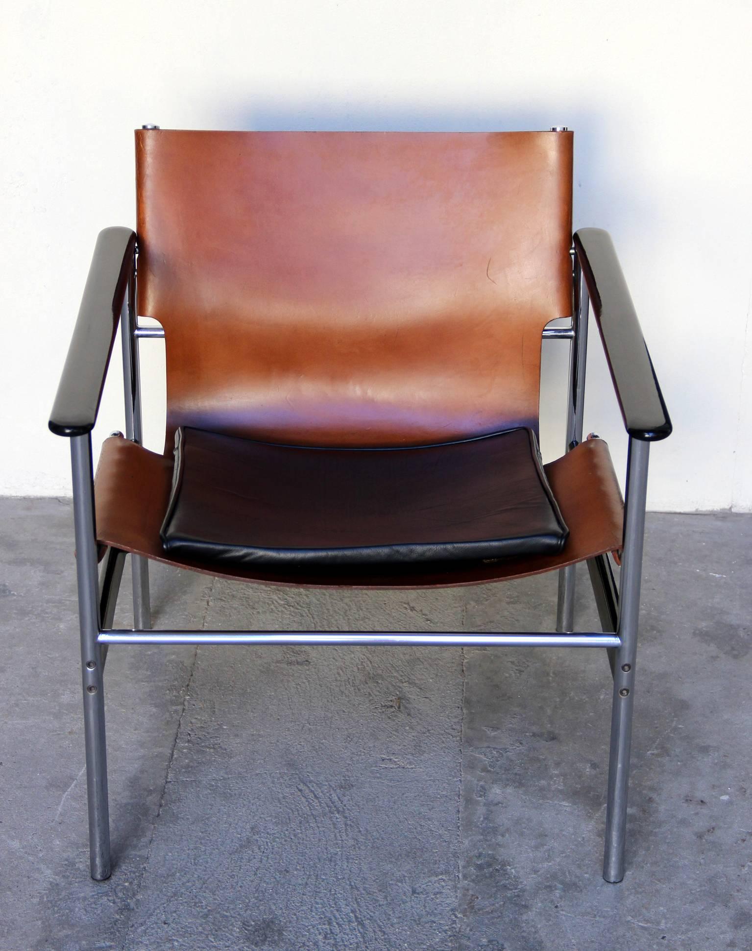 Pair of 657 sling lounge chairs with original tan leather sling seats with attached black leather seat cushion. In a tubular frame with black resin coated aluminium armrests. Made in 1964.

Two pairs are available.