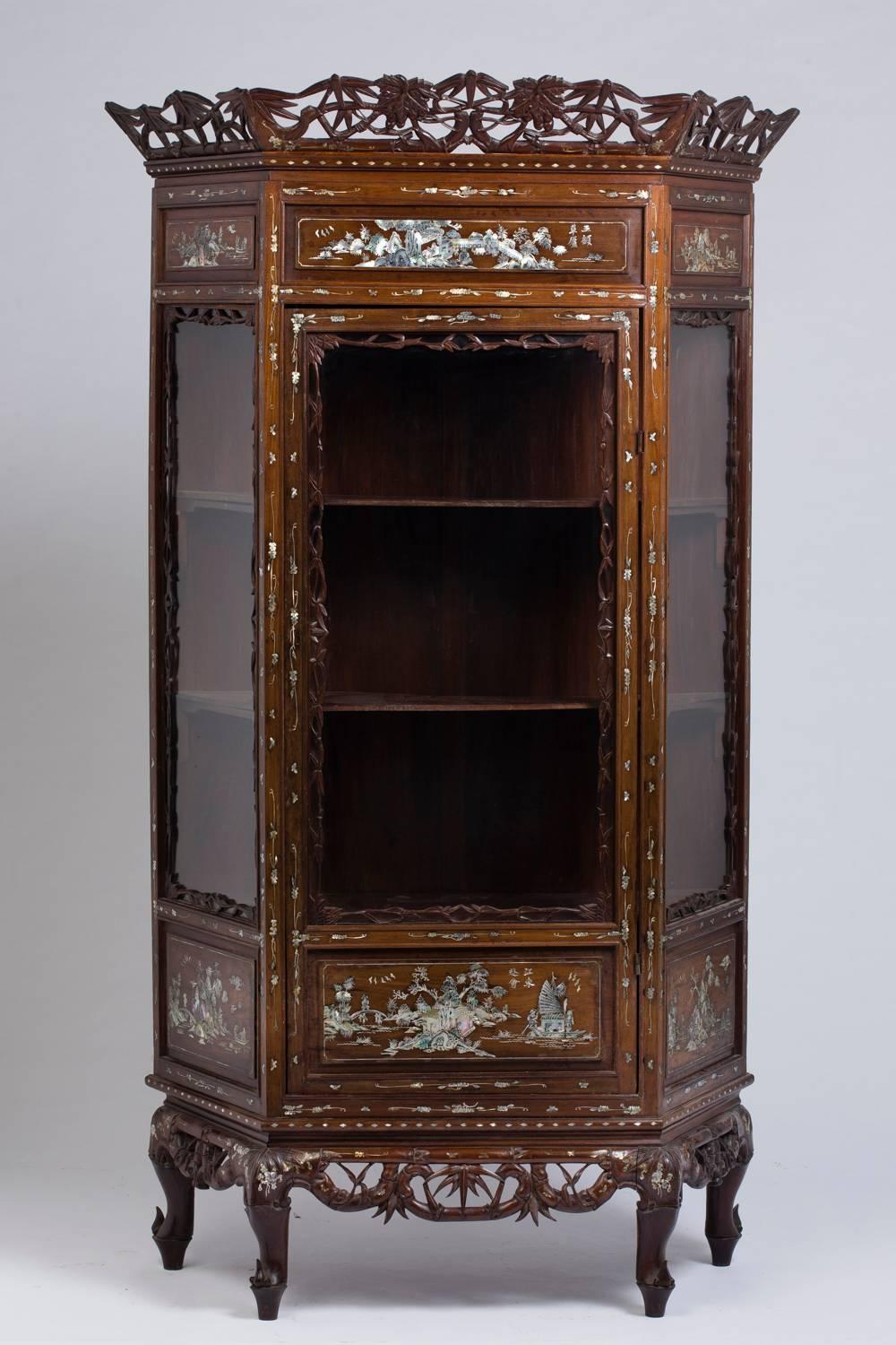 A pair of gorgeous vitrines in carved wood, with numerous incrustations of mother-of-pearl engraved and re-ornamented.
The design of the central panels of each showcase are different from the other.

Depth and width are given without cornices.
 