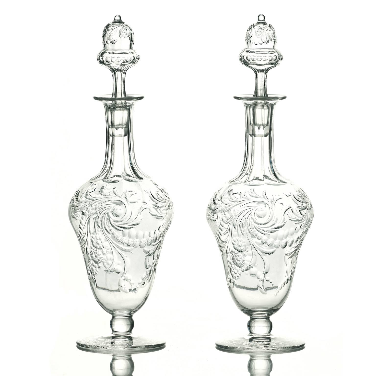 Circa 1890s, Webb, England.  This gorgeous pair of perfumes were made in a graceful baluster shape, hand-engraved in a Florentine-inspired motif and topped with acorn stoppers. Perfect for a vanity, they are fabulous for display. Beautifully