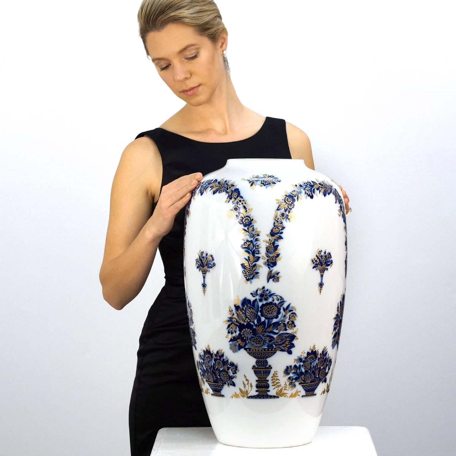 Circa 1920s-30s, marked on bottom of vase "Heinrich, Germany, and Hofgarten". These 21.5-inch-high porcelain vases are magnificently decorated in cobalt blue and gilded Italianate motifs inspired by the Court Gardens  in Munich. 