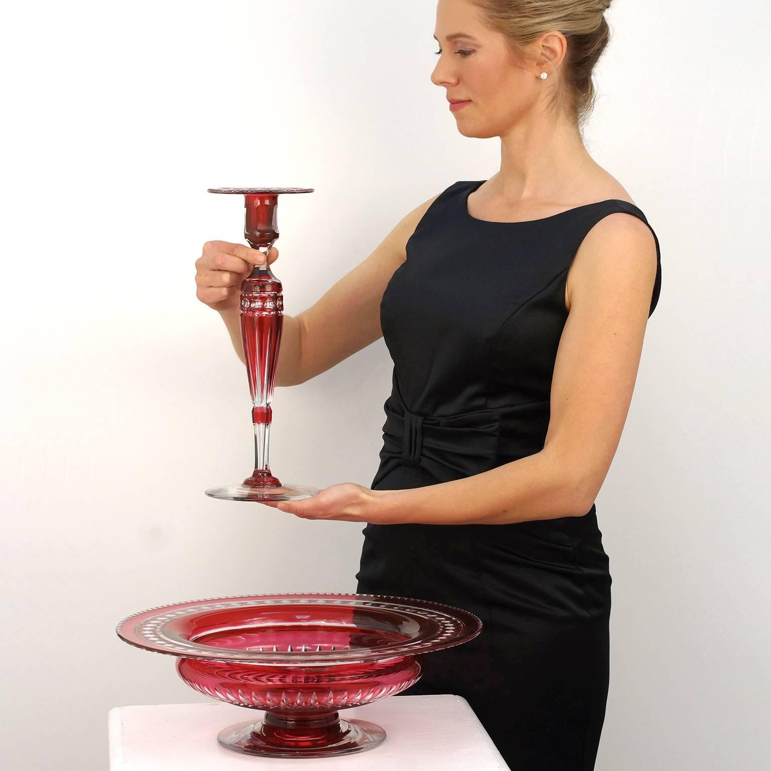 Circa 1930s, by Val St. Lambert, Belgium. This elegant Val St. Lambert creation features a stunning centerpiece bowl and four striking candlesticks, all exquisitely hand-cut in cranberry cased glass. The footed bowl is massive at 15 ¾ inches in