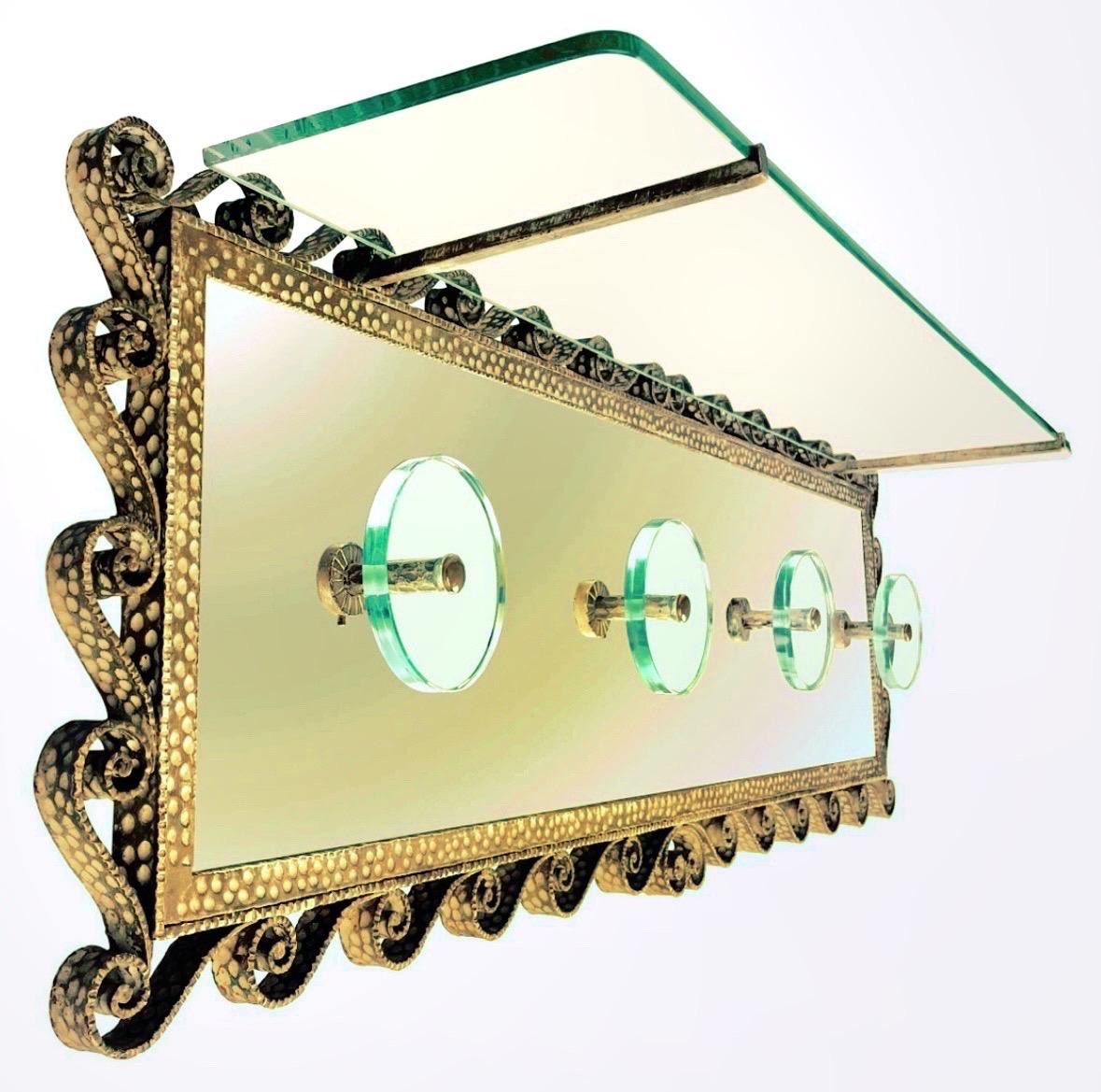 Elegant and refined handcrafted brass coat rack, gold-colored mirrored glass, produced by Pierluigi Colli for Cristal Art 1950s. Including rectangular glass on top. Presence of two round patinas on the glass, caused by 'wear and tear of time.. Upper