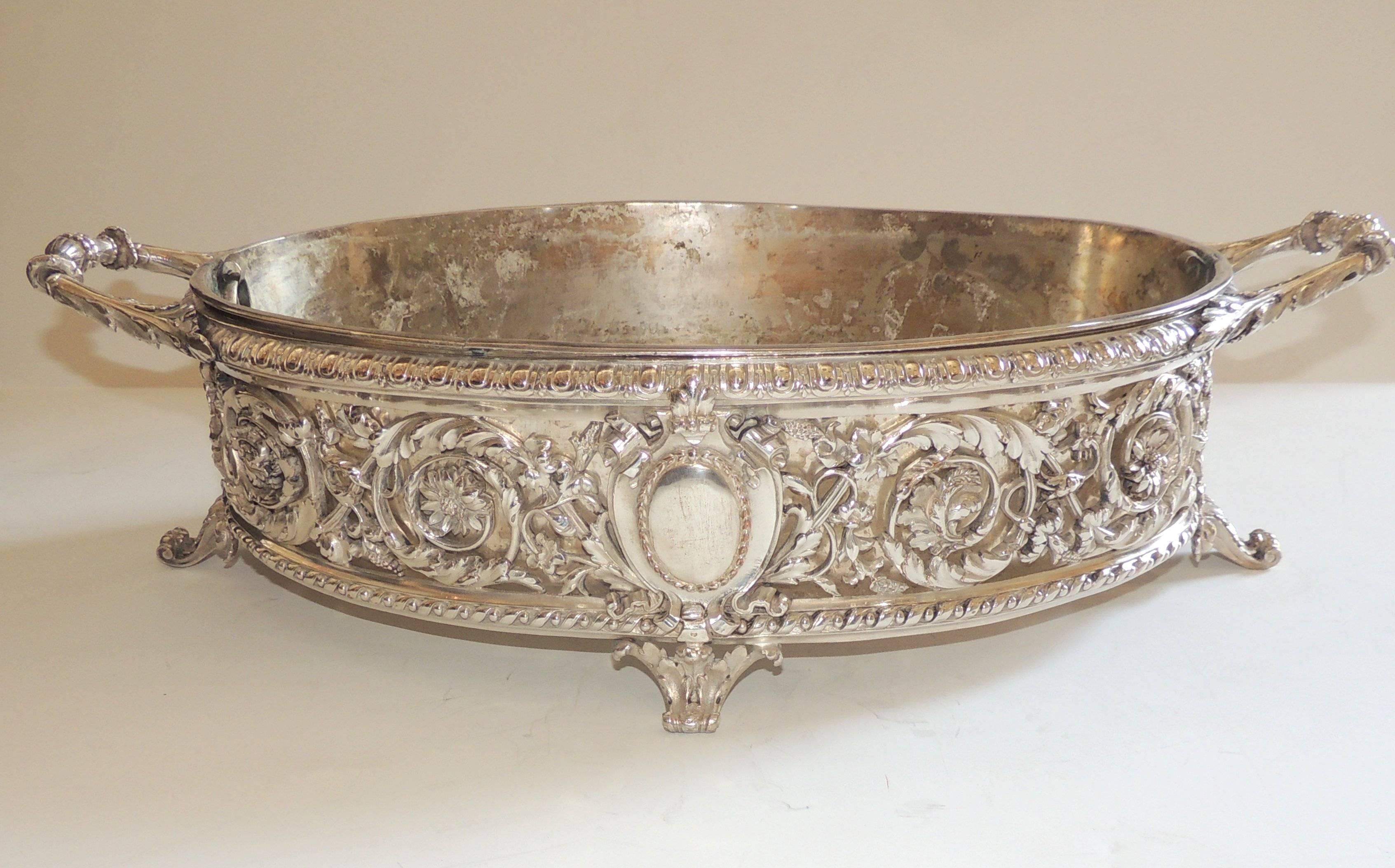 This Wonderful French silver plated centerpiece with insert Is by Christofle it is beautifully adorned with filigree pierced design and centered with a crest ending on either side with very fine detailed handles & feet. 

Marked Christofle