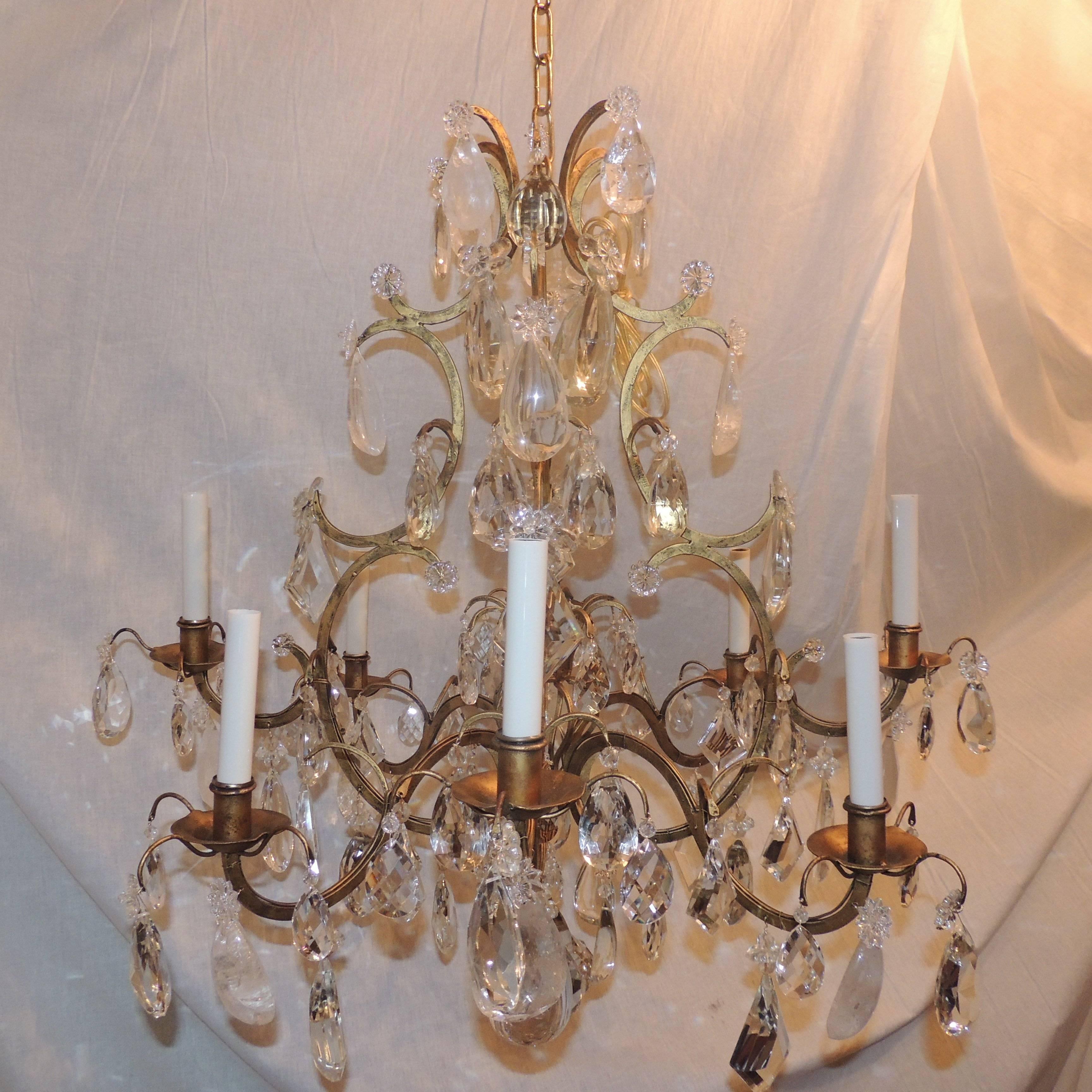 This large Baguès chandelier with eight arms has six layers of beautiful rock crystal and faceted prism drops decorating the sweeping curved doré bronze body.

Measures: 32" H x 32" W.