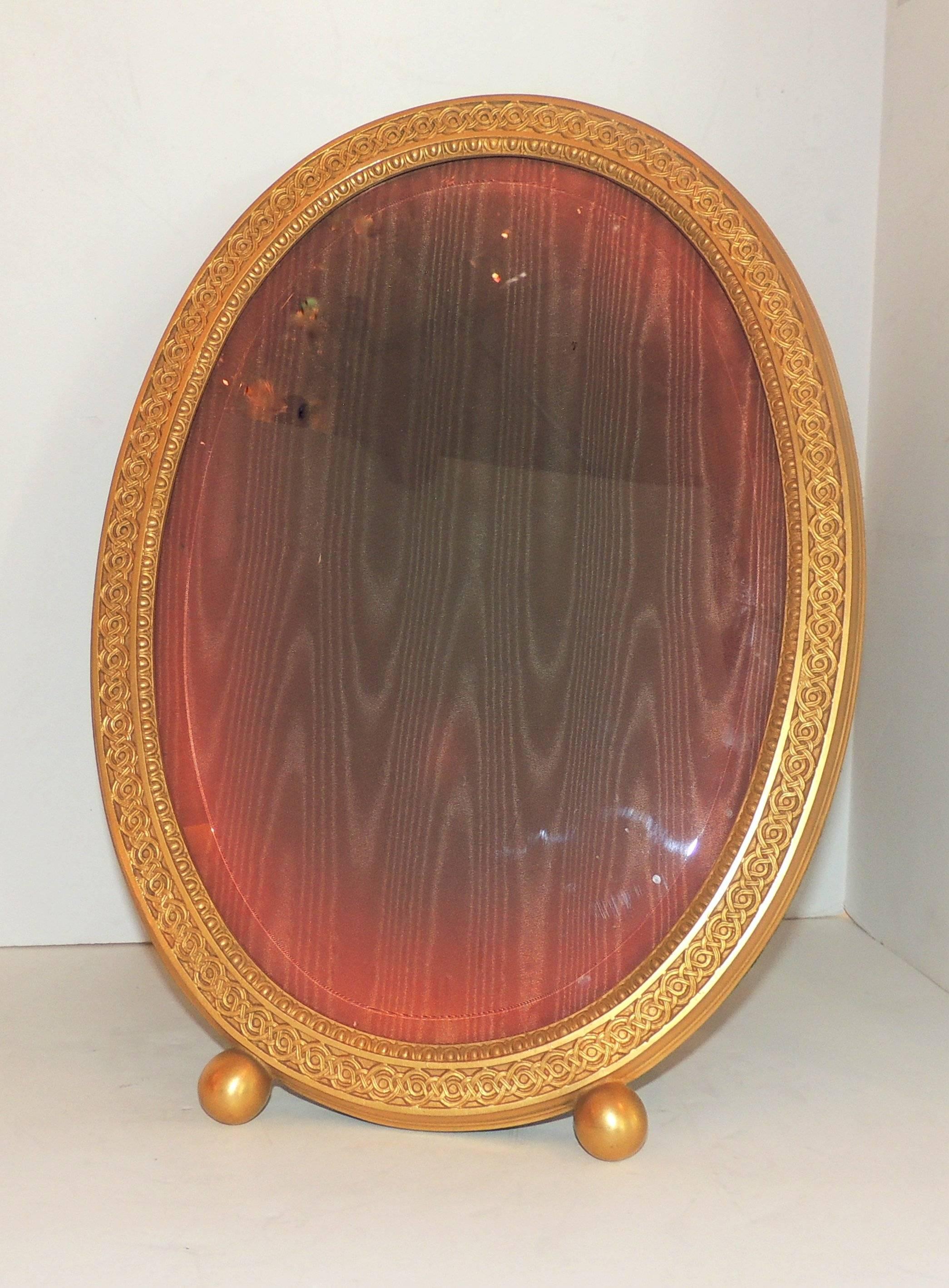 Wonderful etched design surrounds this large marked Gorham Gold gilt dore picture frame with beveled glass. 

Measures: 16