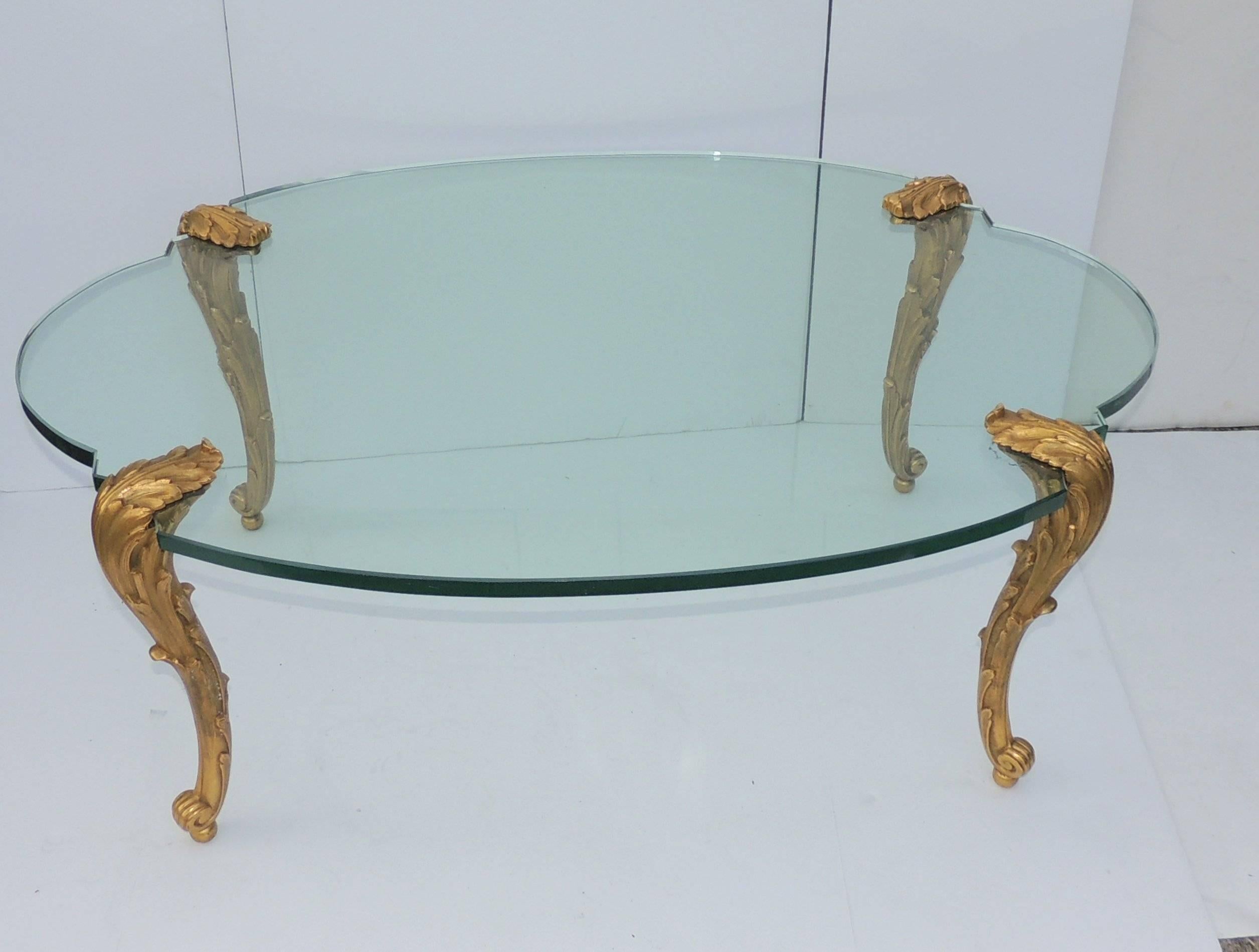 Wonderful oval shaped coffee table with thick cartouche glass and beautiful bronze Guerin detailed legs.

Measures: 29 