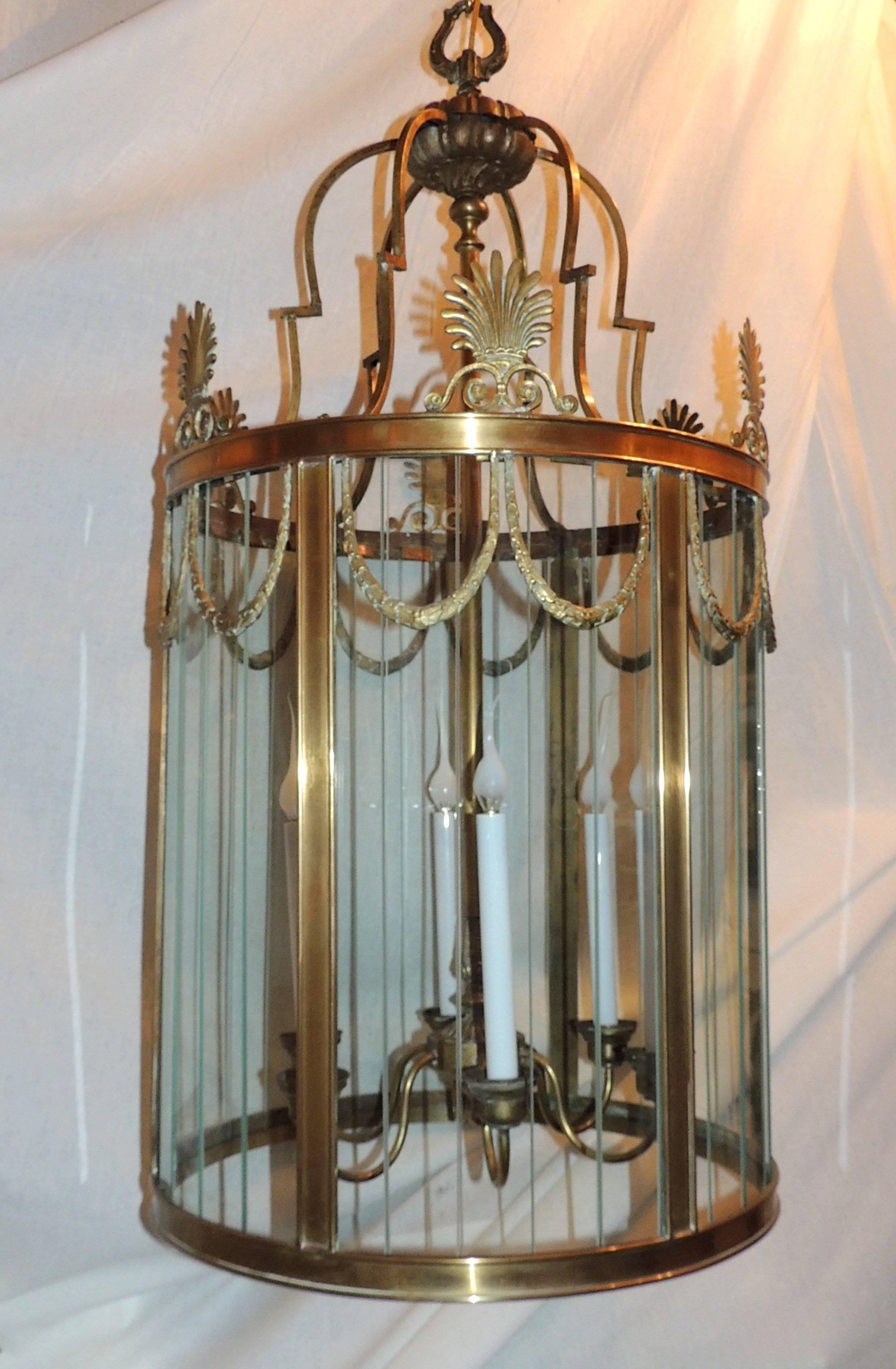 Wonderful large six-light lantern with multiple glass panels that diffuse the light. 
Acanthus leaves adorn the top with draped filigree wrapping around the sides.

Measures: 40" H x 20" W.
    