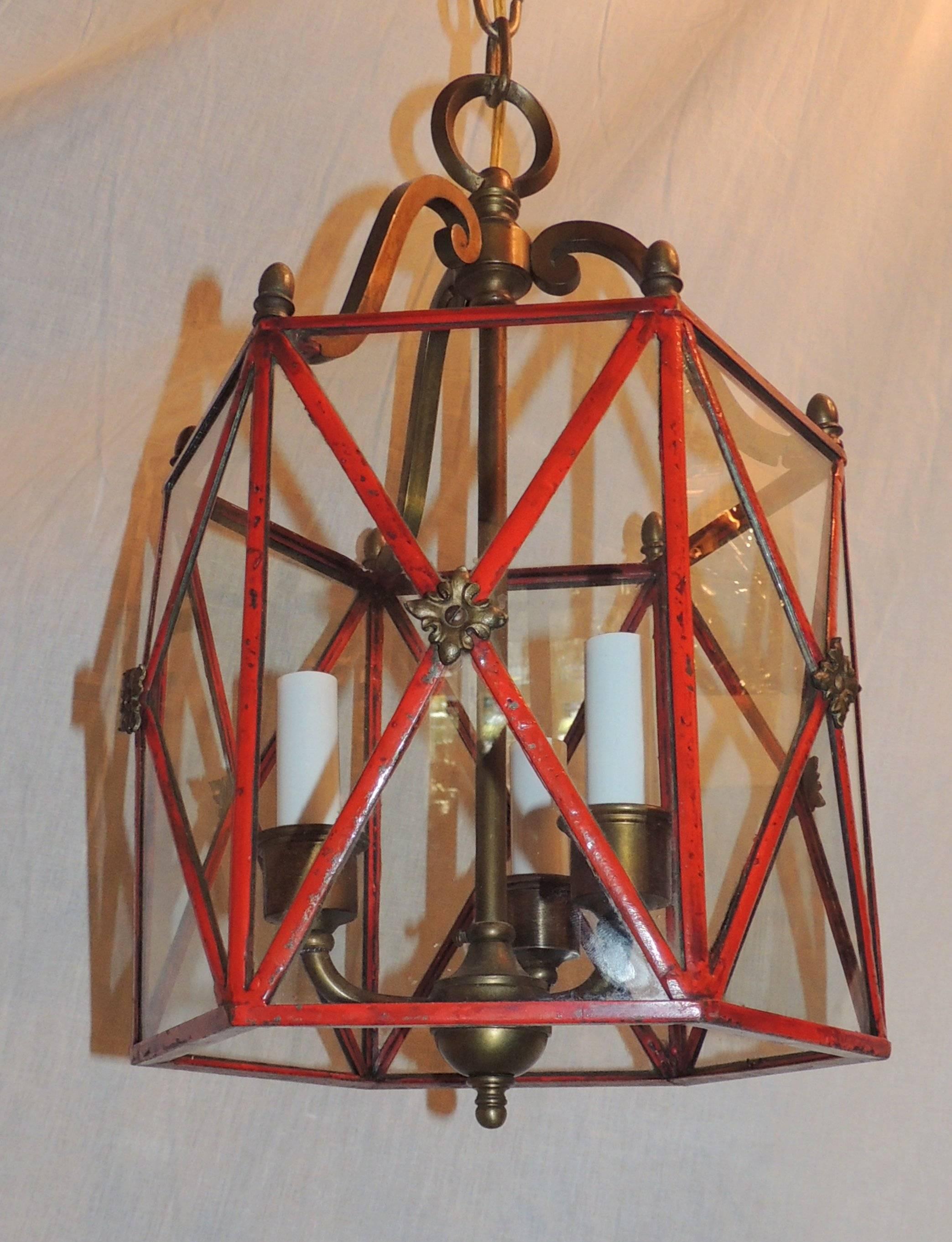 This wonderful petite three-light lantern is in a hexagon shape with glass panels, the sides bowed out accented with bronze floral accents. 
Completely rewired and ready to install.

Measures: 9" W x 16" H.