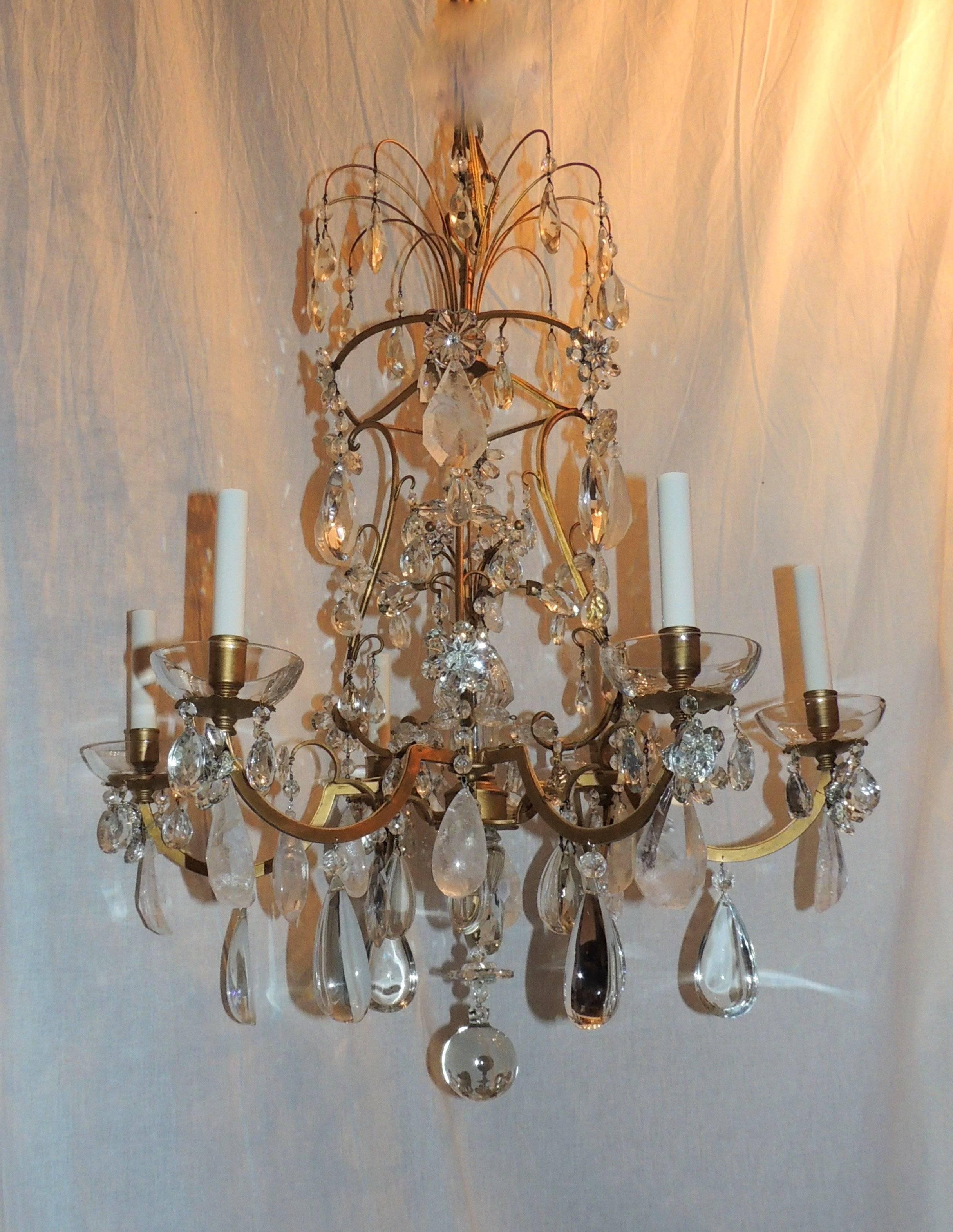 A beautiful chandelier with an interior pagoda shape, topped with a spray of crystal prisms, the center has a spray of crystal flowers and crystal florals accent each of the six arms with glass bobeches. A mix of prism, crystal and rock crystals