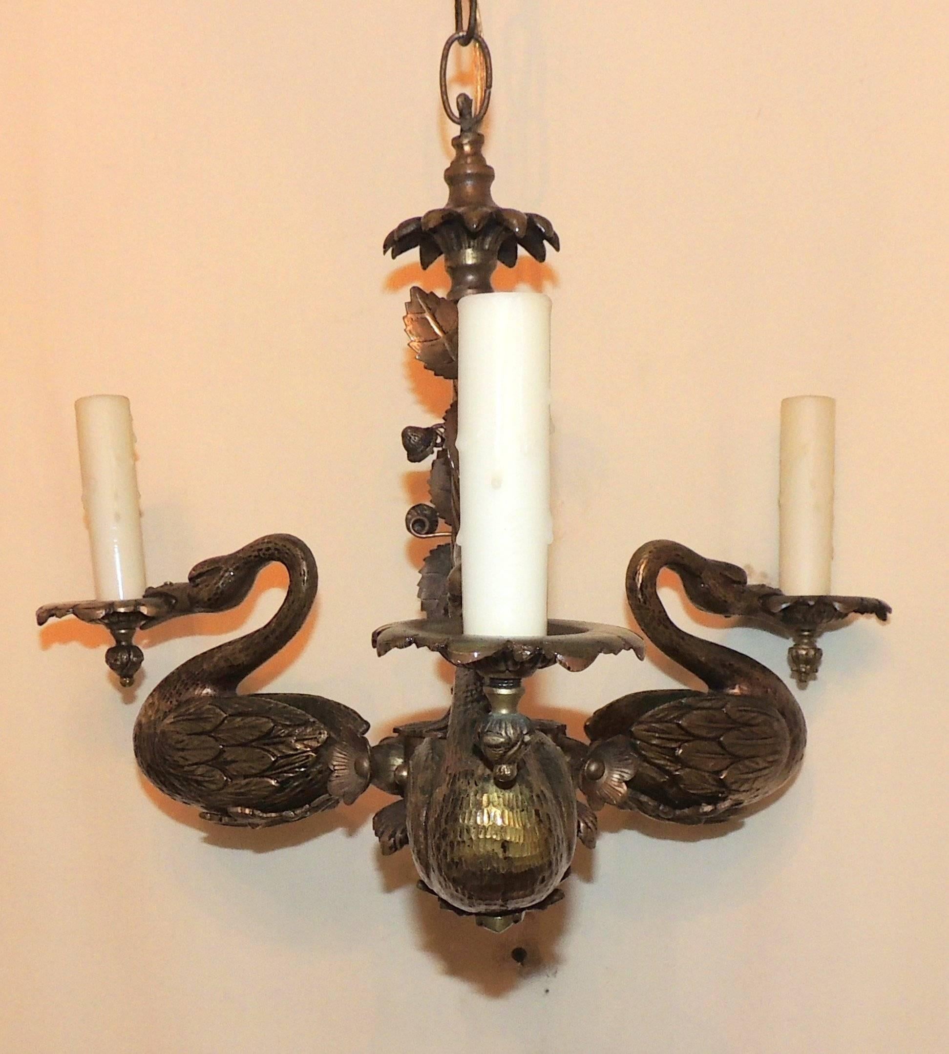 Wonderful three-arm doré bronze swan chandelier, beautifully detailed from the column center with filigree leaves, flower accents and the three lovely swans with etched feathers. This chandelier has a wonderful dark aged patina. The accent pictures
