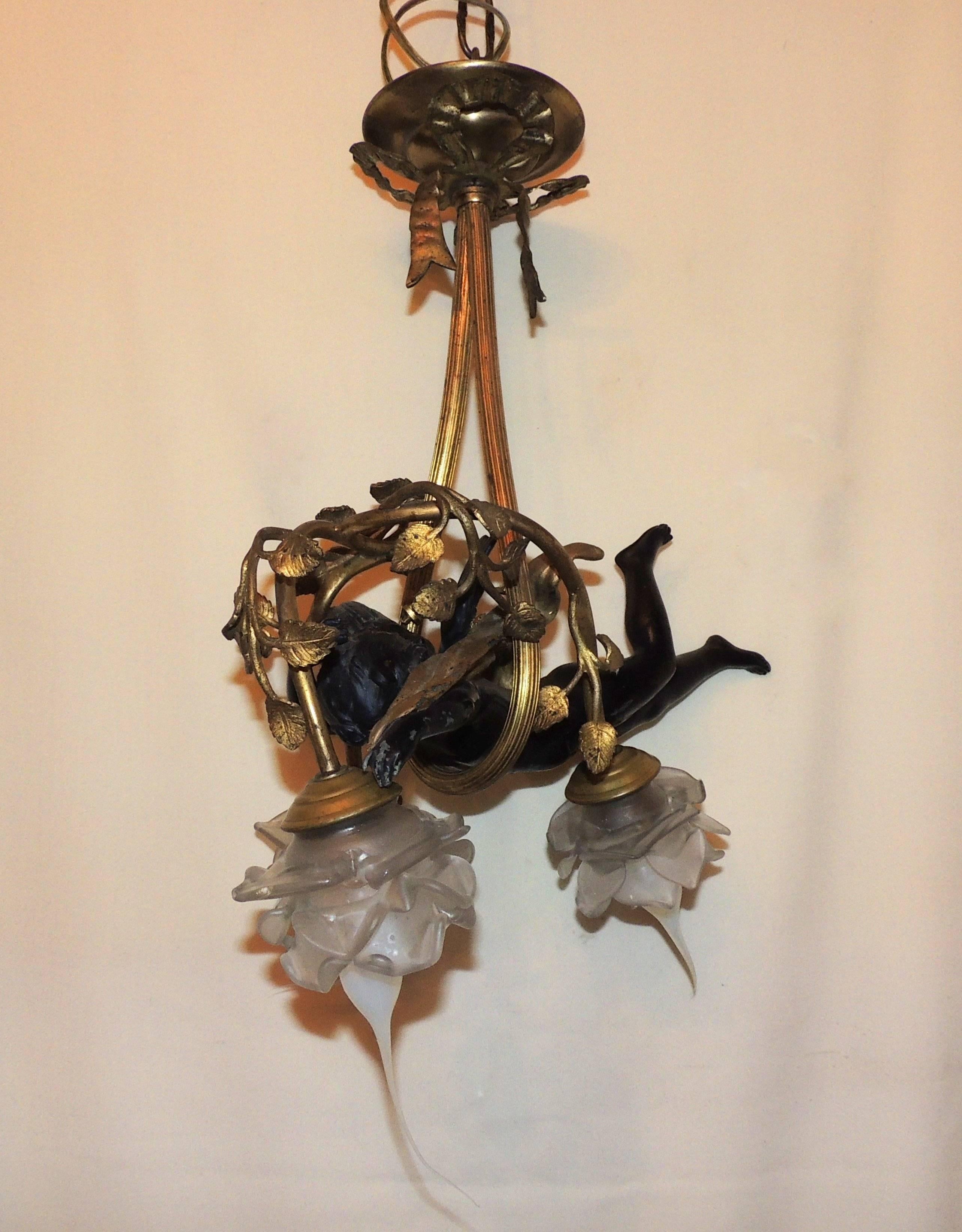 A lovely French doré bronze chandelier has a ribbon supporting the sweet cherub in the branches with three lights. Original frosted flower shades accent the leaf decorated branches.

Measures: 18" H x 10" W.