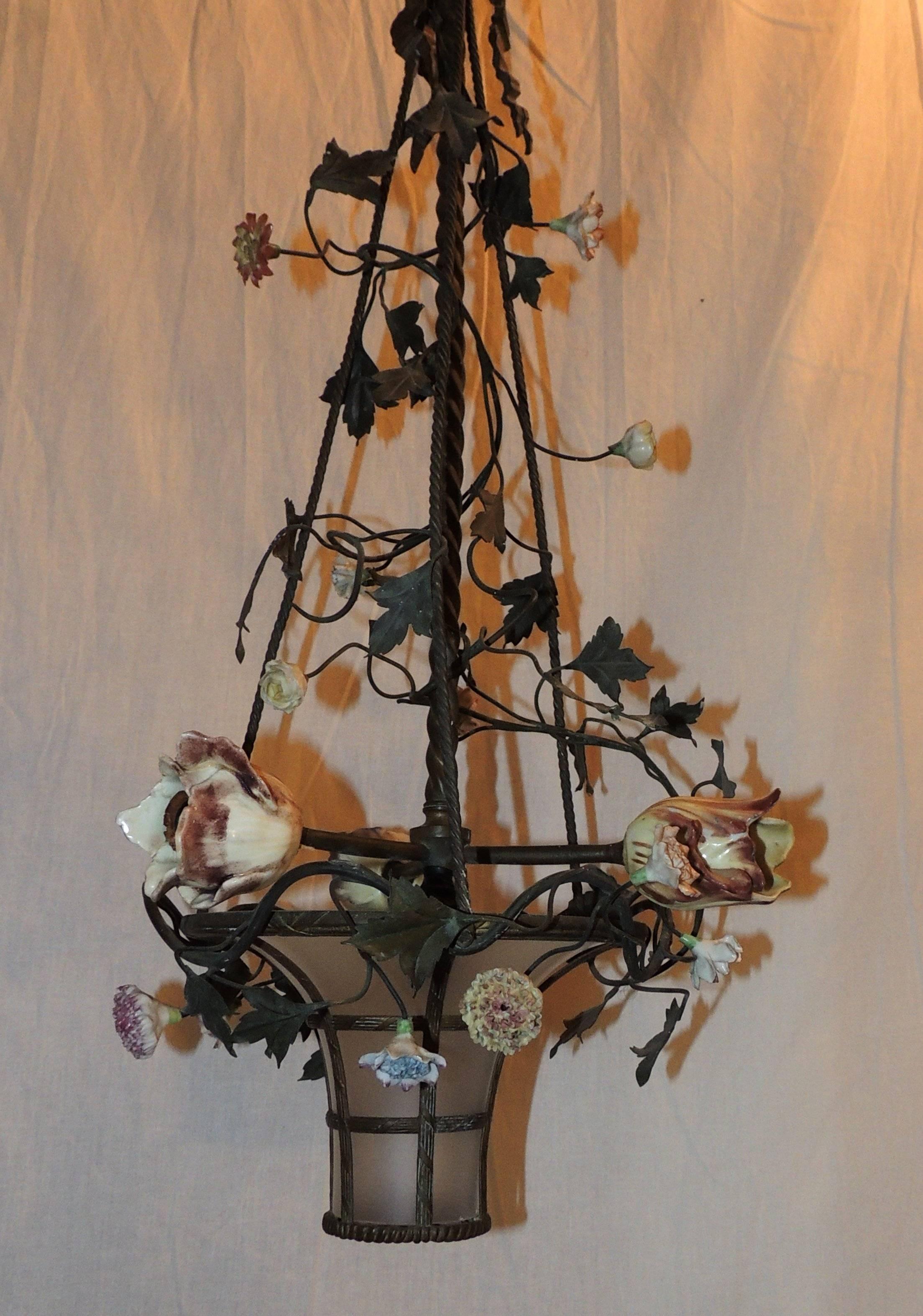 Wonderful assortment of porcelain flowers and bronze ivy decorate this frosted glass basket with three flower light chandelier.

Measures: 24" H x 12" W.