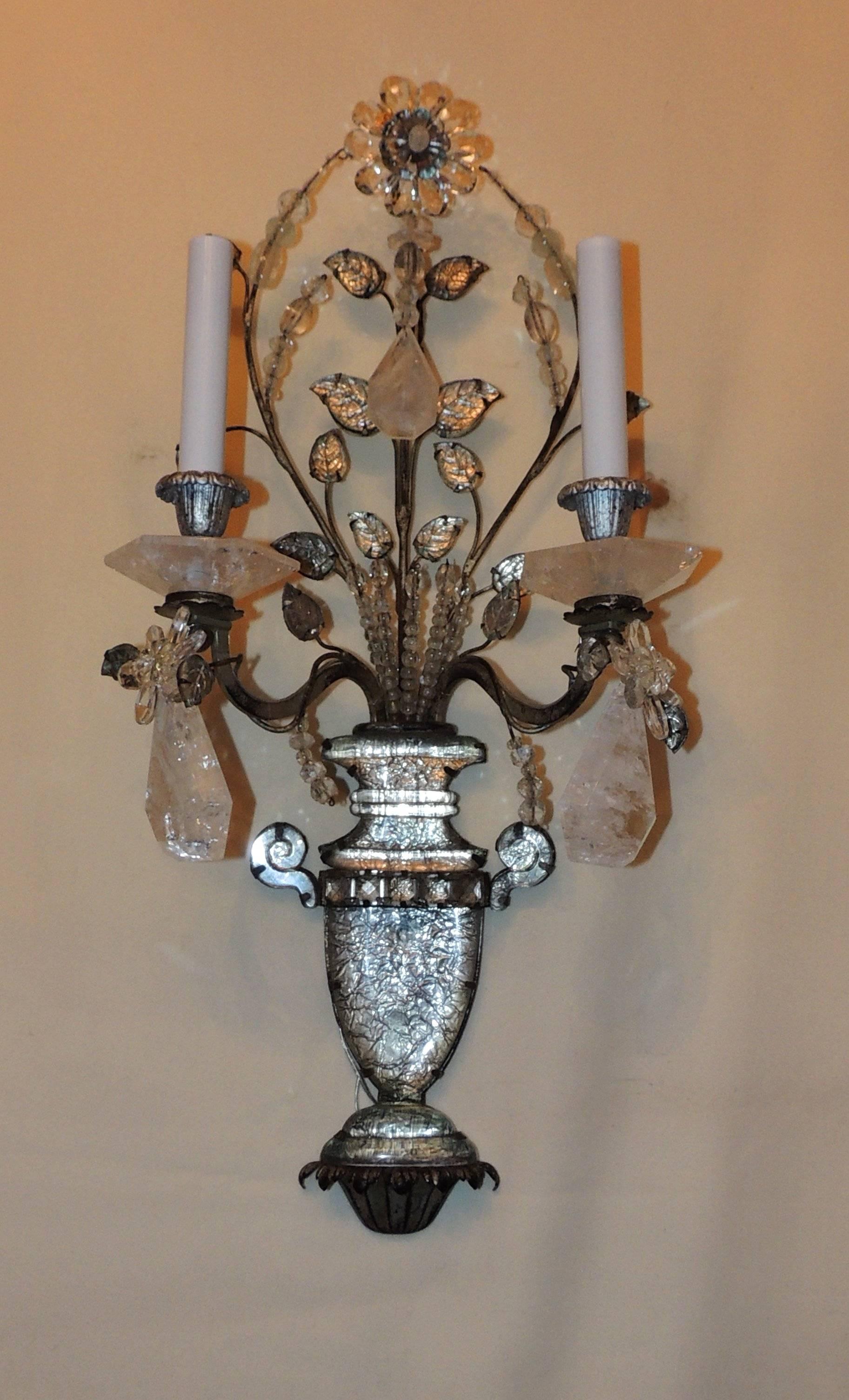 Wonderful pair of stamped made In France rock crystal silvered bronze two-arm Jansen sconces
Measures: 25" H x 11.5" W x 6" D.