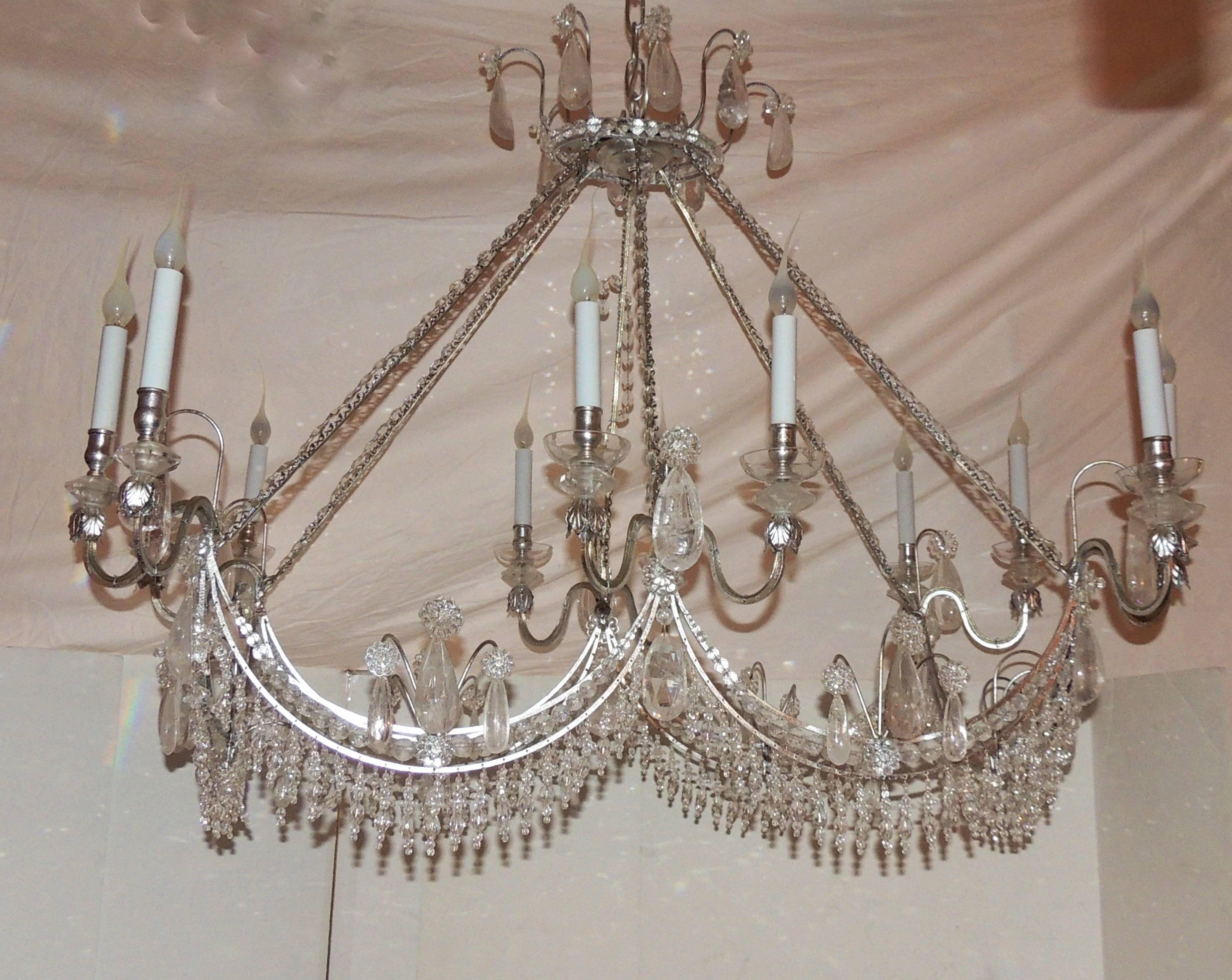 A wonderful and unusual silver gilt, crystal swag and rock crystal rectangular form chandelier eight light fixture.

Measures: 33
