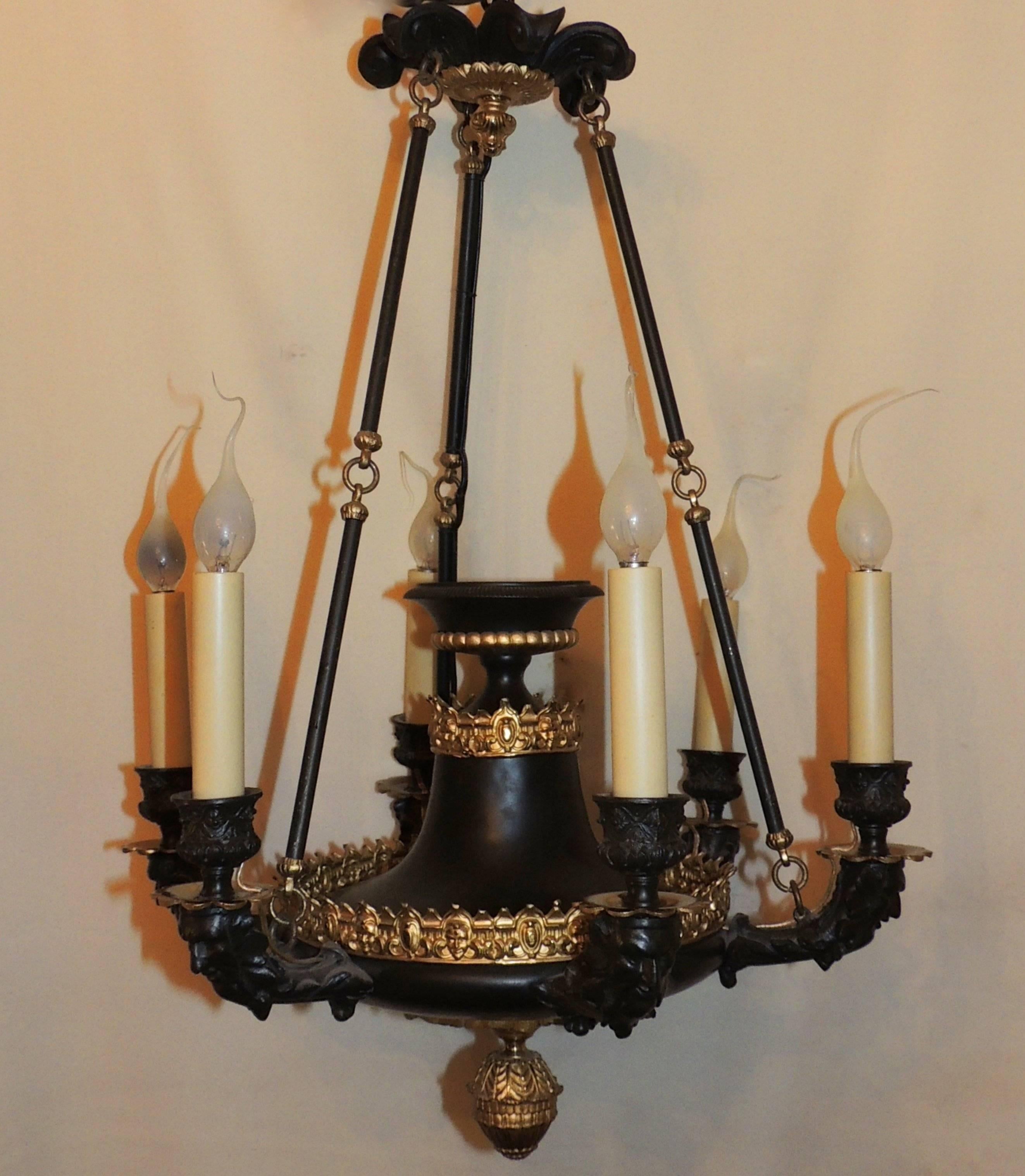 A fine French empire patinated and gilt bronze figural neoclassical Regency urn center chandelier.

Measures:  20." H x 16" W