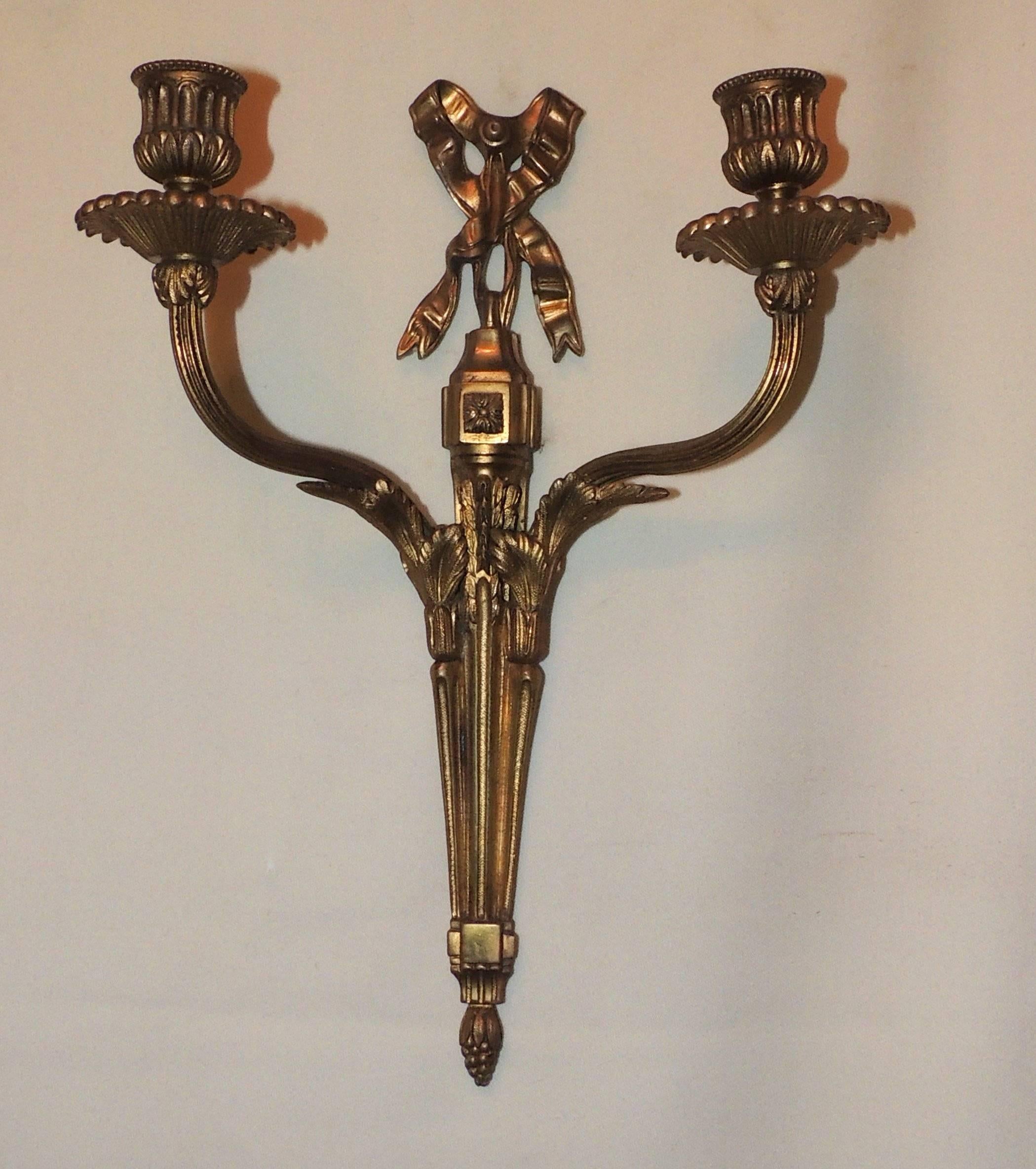 Wonderful set of four bow top neoclassical two-arm sconces

Very Fine work on bronze with bow tops and filigree details

Can be electrified.

Sold by the pair.