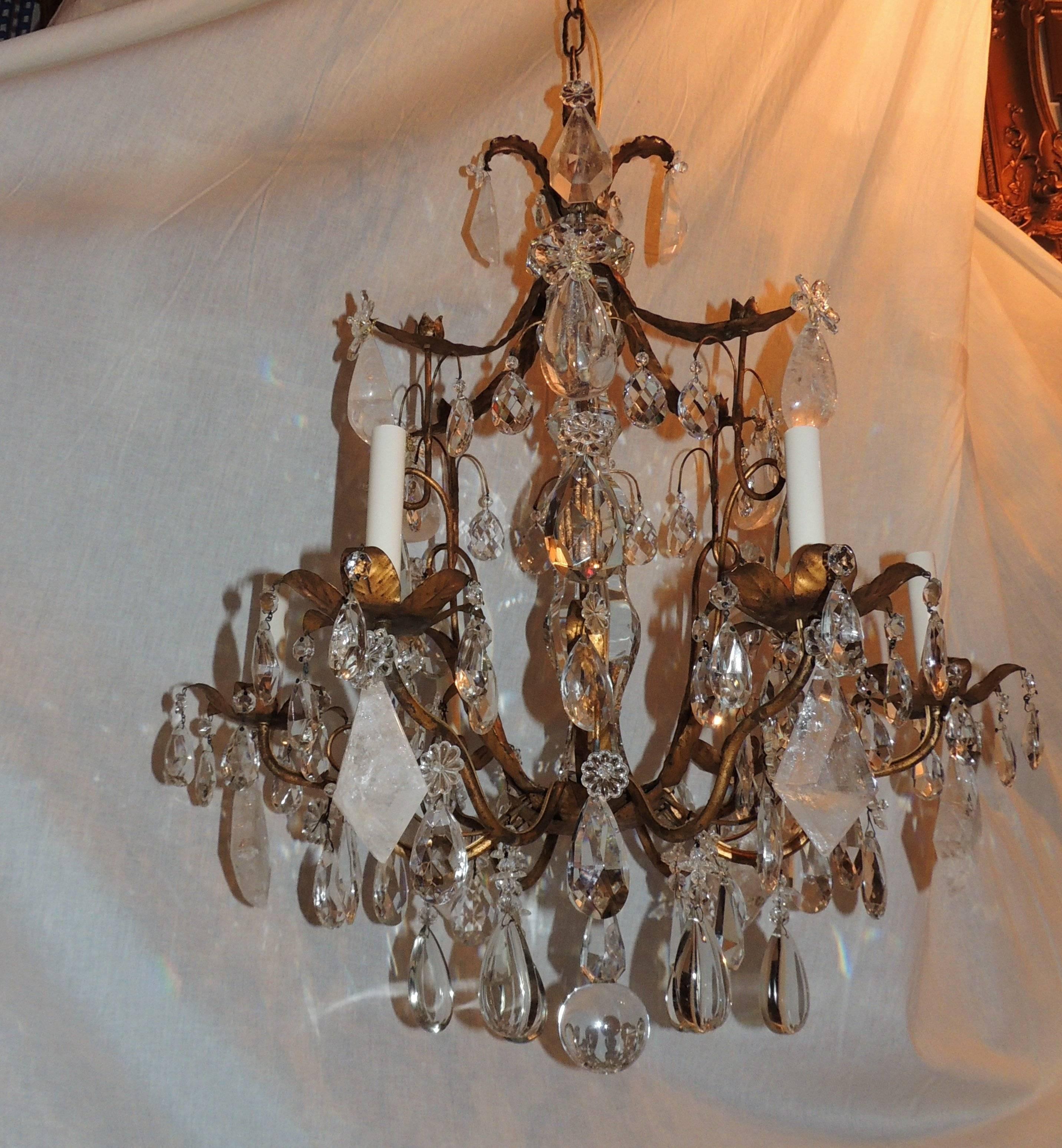 Doré bronze leaves accent the Pagoda shape of this Bagues style chandelier with rock crystal and crystal throughout.

Measures: 32" H x 25" W.
