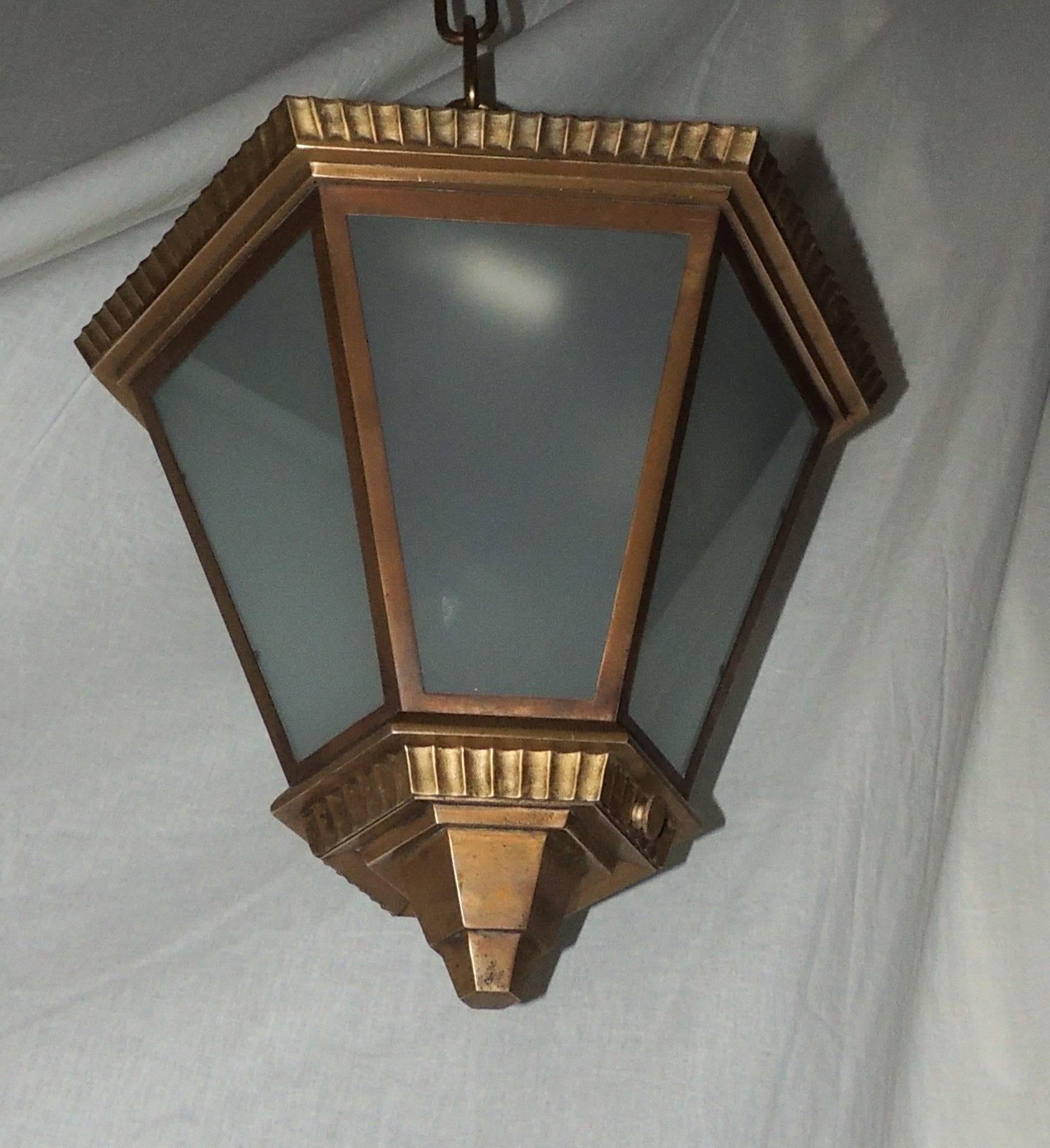 A wonderful Art Deco bronze frosted glass hexagon shaped flush mount pendant fixture with three lights inside.

Measures: 13