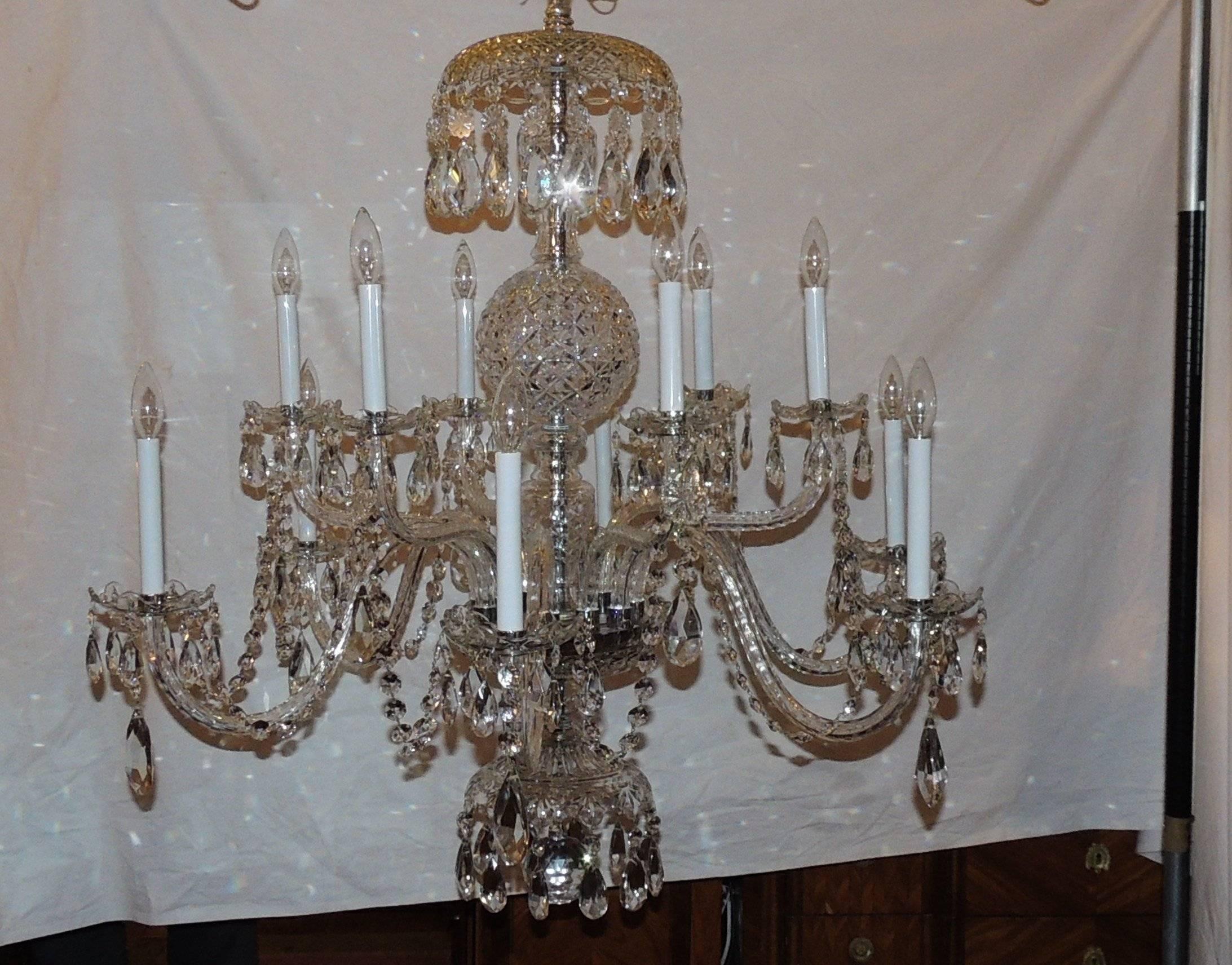 Stunning elegance describes this Waterford style crystal chandelier. The beautiful center columns are intricately designed with different techniques highlighted with a gorgeous center ball. Each of the crystal bobeches are ringed with beautiful