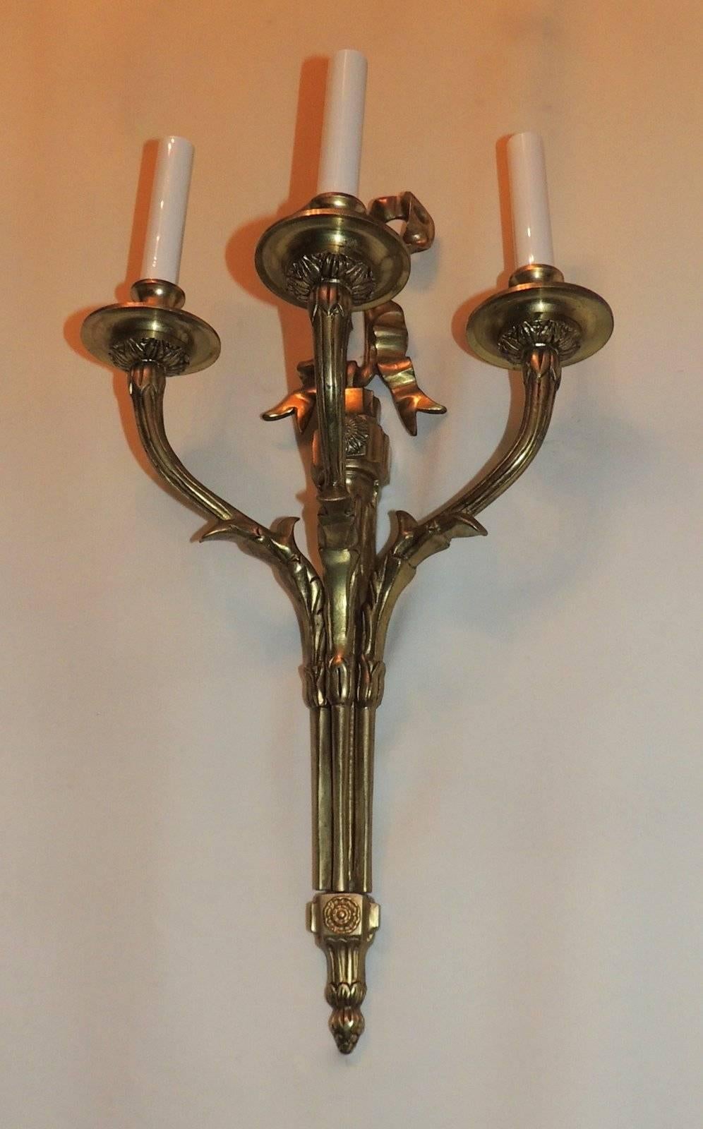 Elegant set of six (three Pair) of gilt bronze three arm French Sconces with bow top and rosette detail. The three arms are decorated with filigree detail.

Sold per pair
Three pairs available

Measures: 21