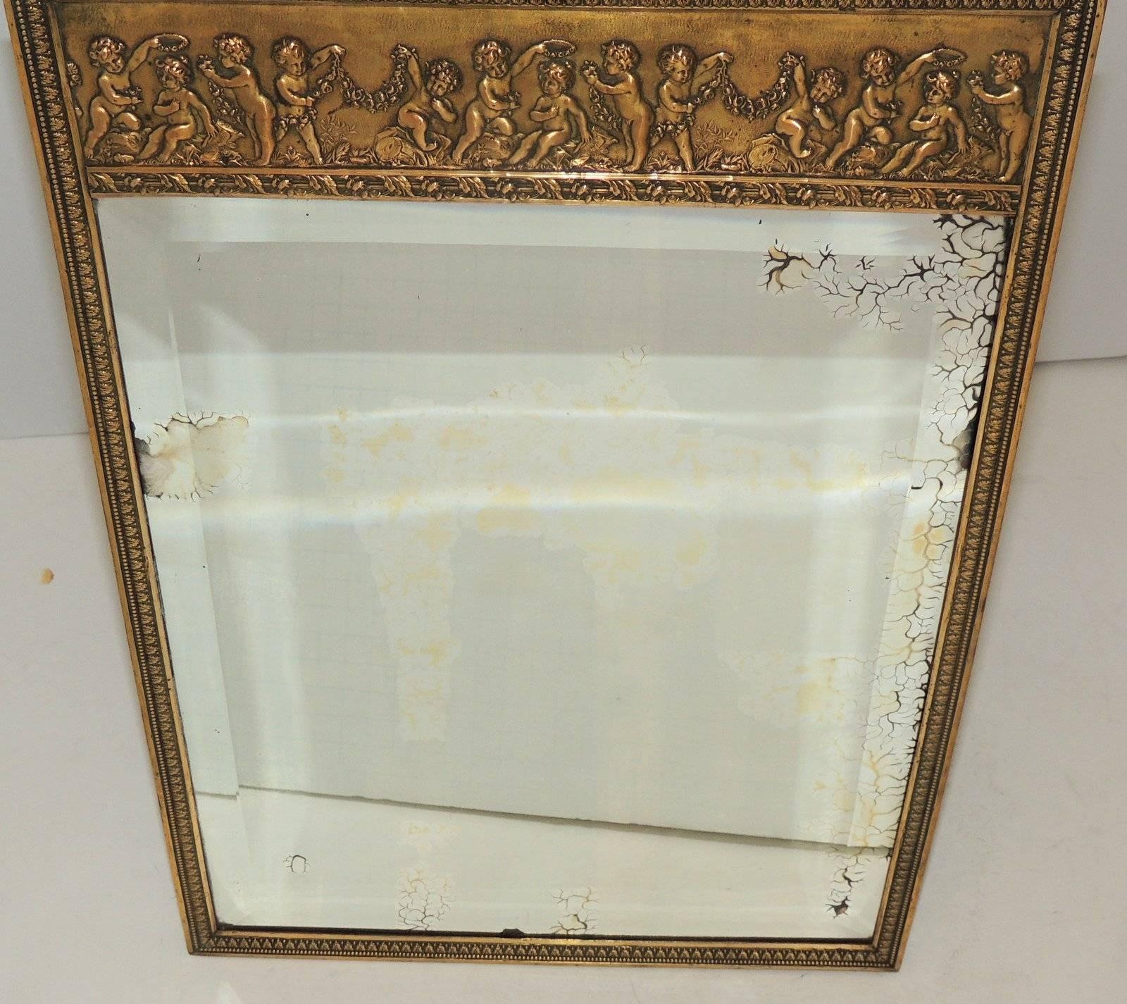 Wonderful antique beveled edge mirror frame with Cherubs across the top and etched detail surrounding the sides. The mirror has beautiful age to the silver and has easel back or ring to hang.

Measures: 16 in. high x 11.25 in. wide.