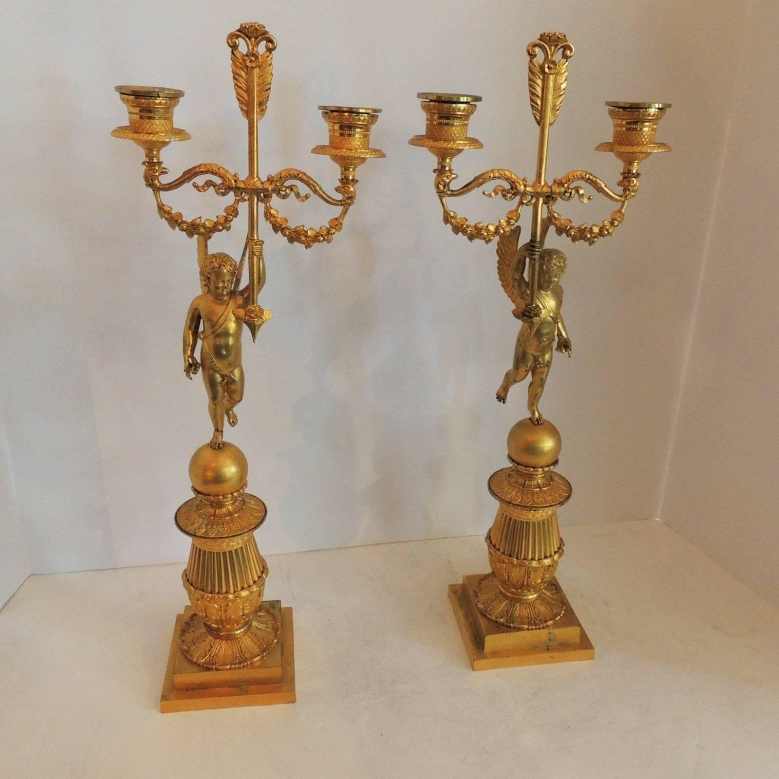 A wonderful pair of doré bronze two-arm winged putti cherub neoclassical candelabras
Measures: 18" H x 6.5" W x 4" D.