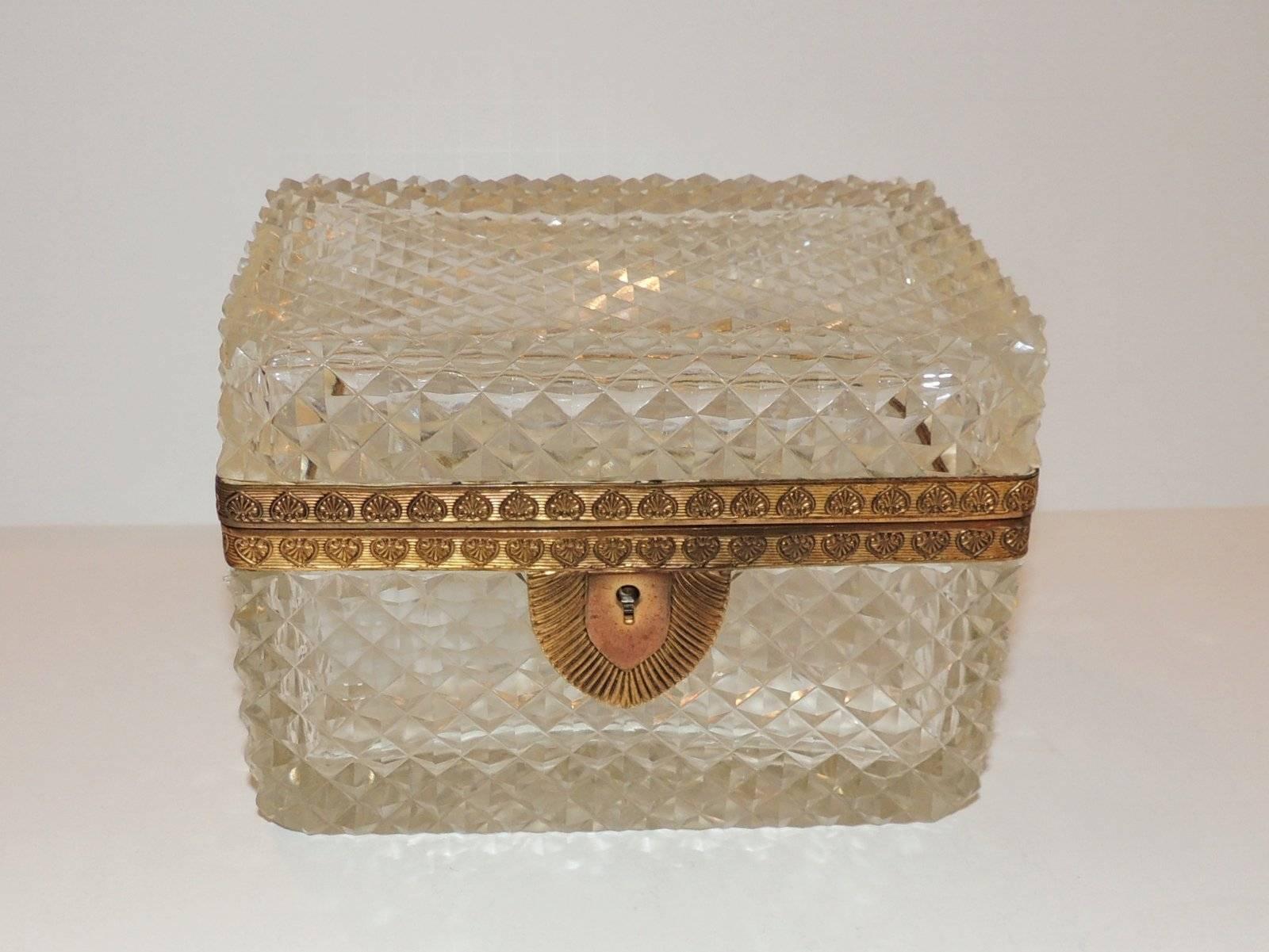 Wonderful diamond shaped crystal box and engraved ormolu with star burst bottom.

Measures: 5.5" W x 4" H x 3.75" D.
