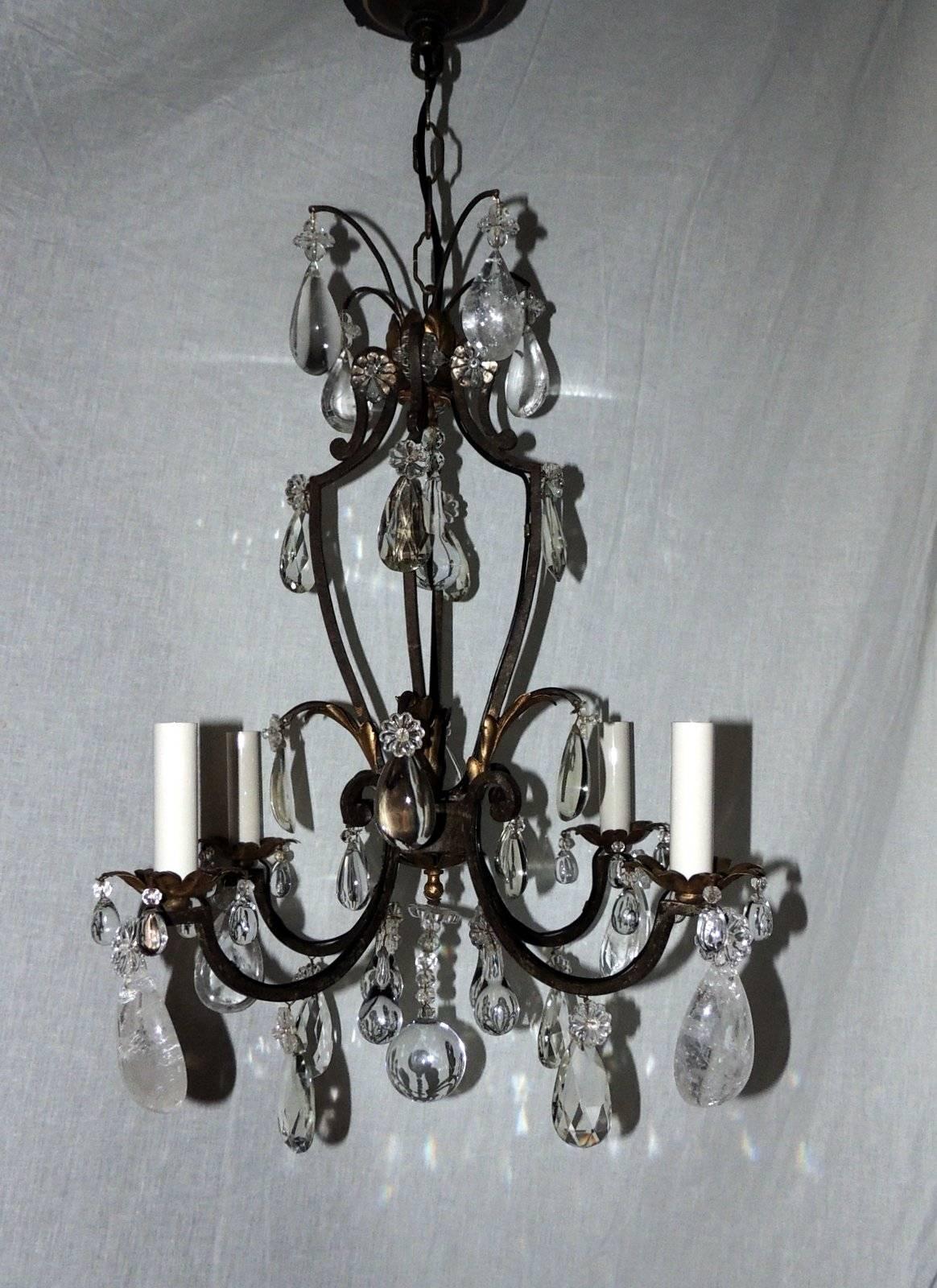 A wonderful French gilt rock crystal four-light Bagues Jansen Petit light fixture, perfect for the smaller space, this wrought iron chandelier with gilt leaves accenting the center and bobeches.
In the manner of Bagues & Jansen

Measures: 22