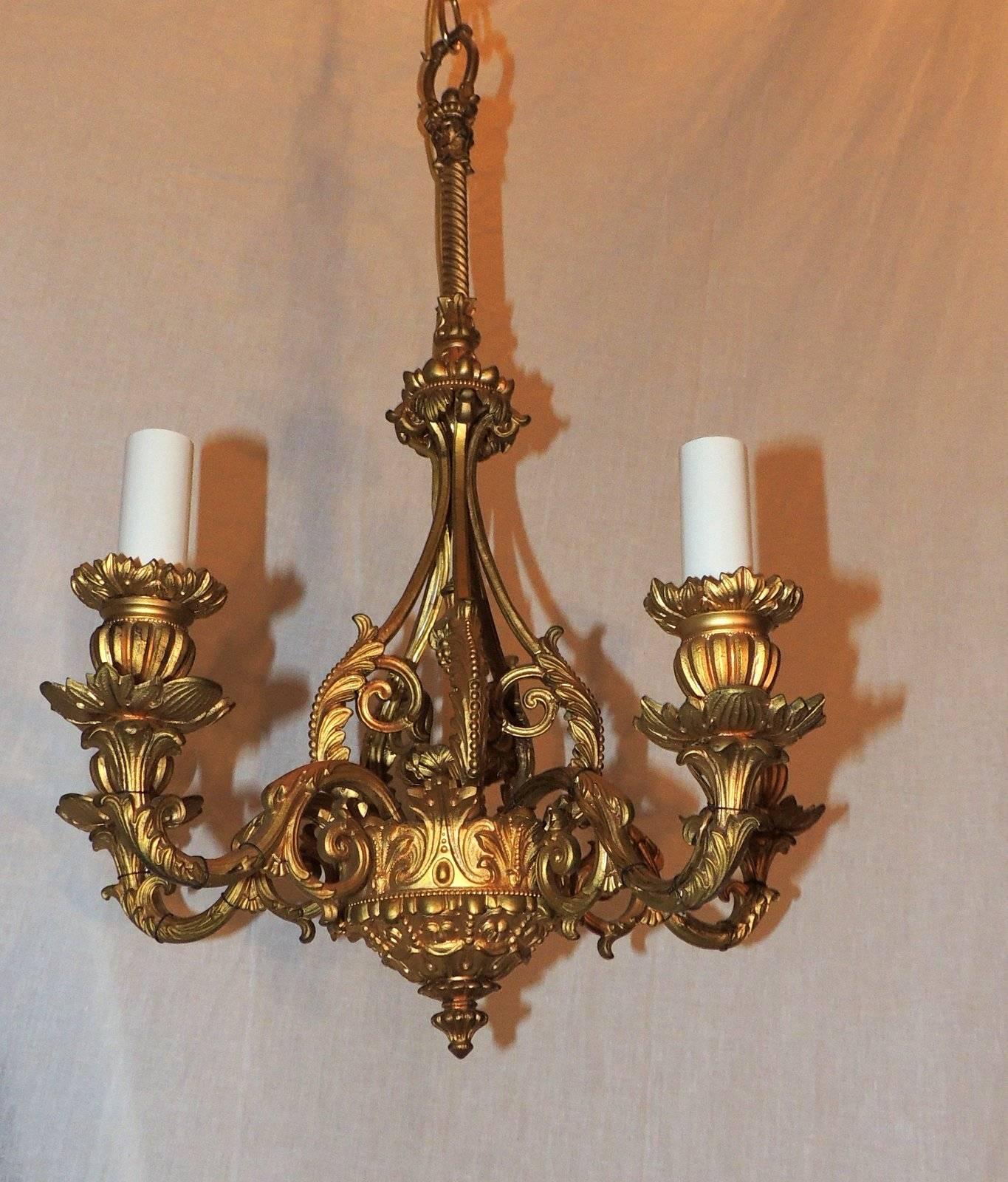 This wonderful pair of Louis XVI Style five-arm chandeliers have intricate doré bronze details throughout.

Measures: 18" H x 12" W

Newly rewired.
