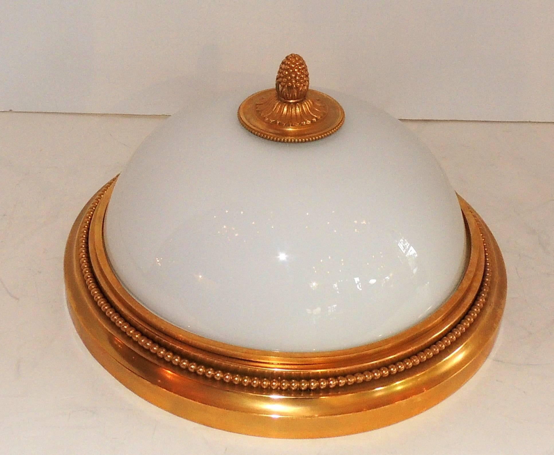 A wonderful Sherle Wagner doré bronze and white dome glass flushmount light fixture. This beautiful fixture is set with two candelabra bulbs taking a maximum of 60 watts per socket. In excellent condition, and come ready to install and