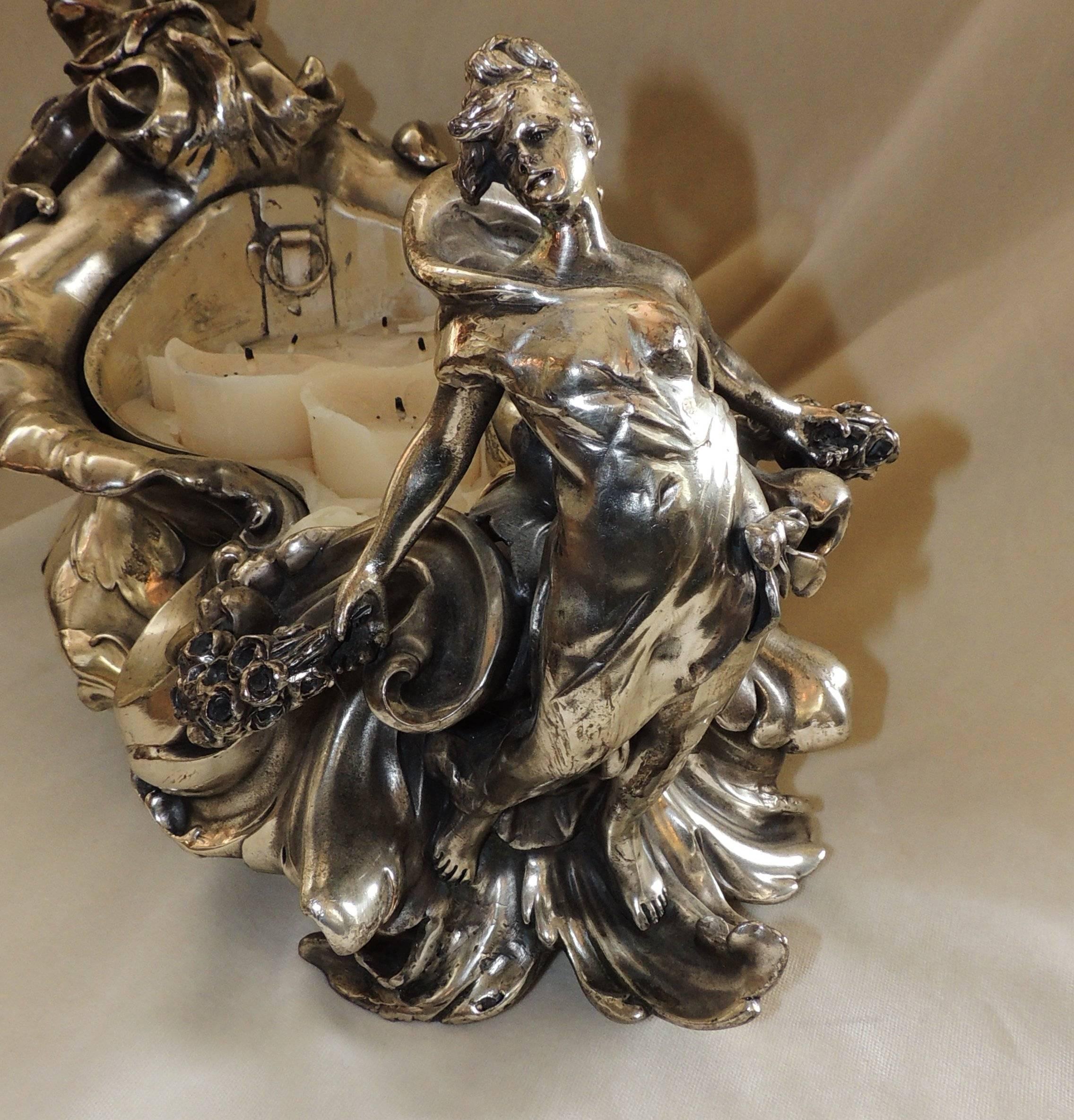 Signed Art Nouveau / Deco silver plated planter centrepiece with liner, decorated with a mermaid, waves, flowers in excellent form flow and details. Signed A. k. Nelson, we believe this piece to be WMF.

Measures: 20" L x 11" W x
