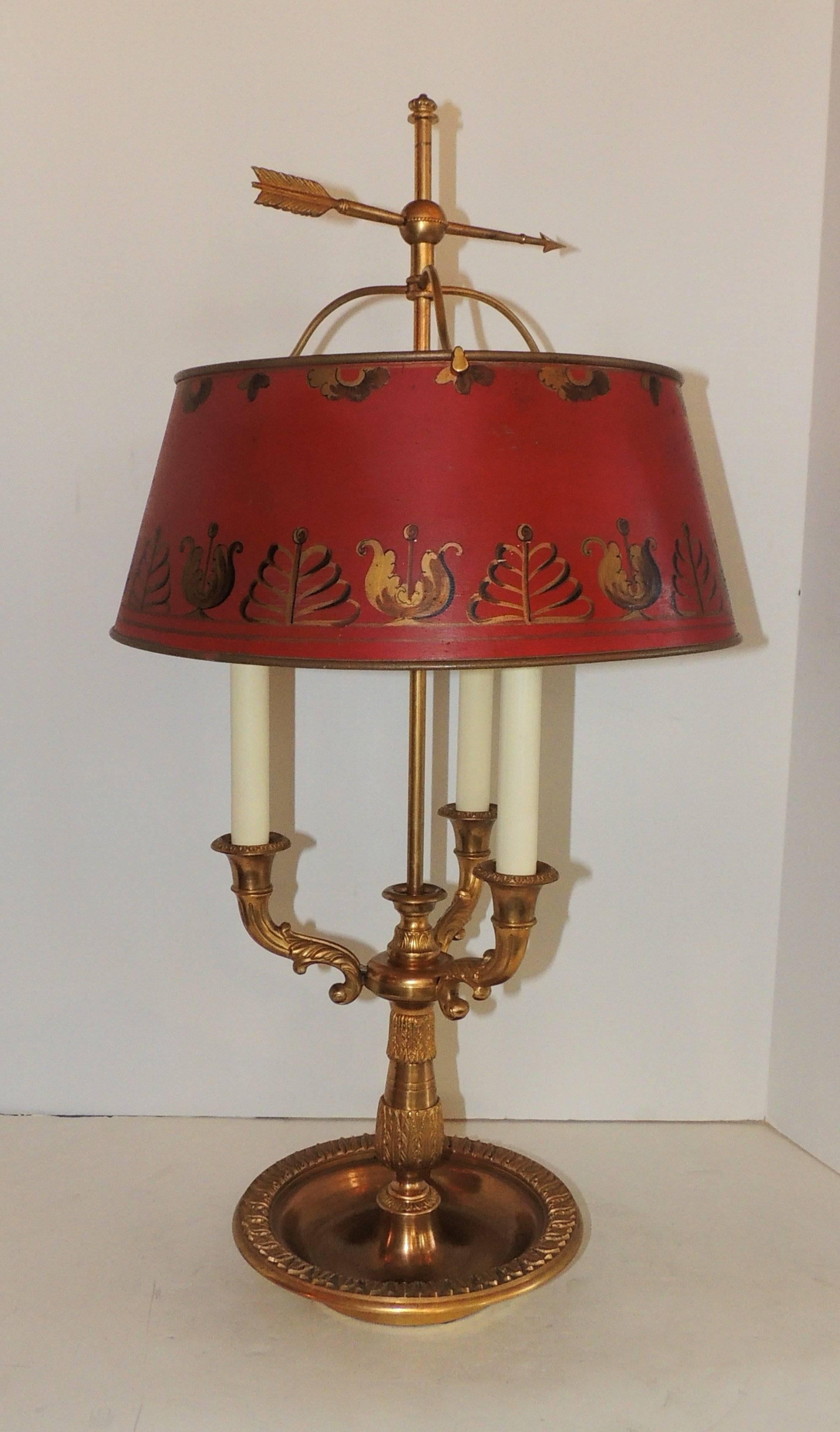 A wonderful pair of French bronze neoclassical Bouillotte lamp with three lights and decorated red tôle shade in the Regency motif.

Measures: Shade 14