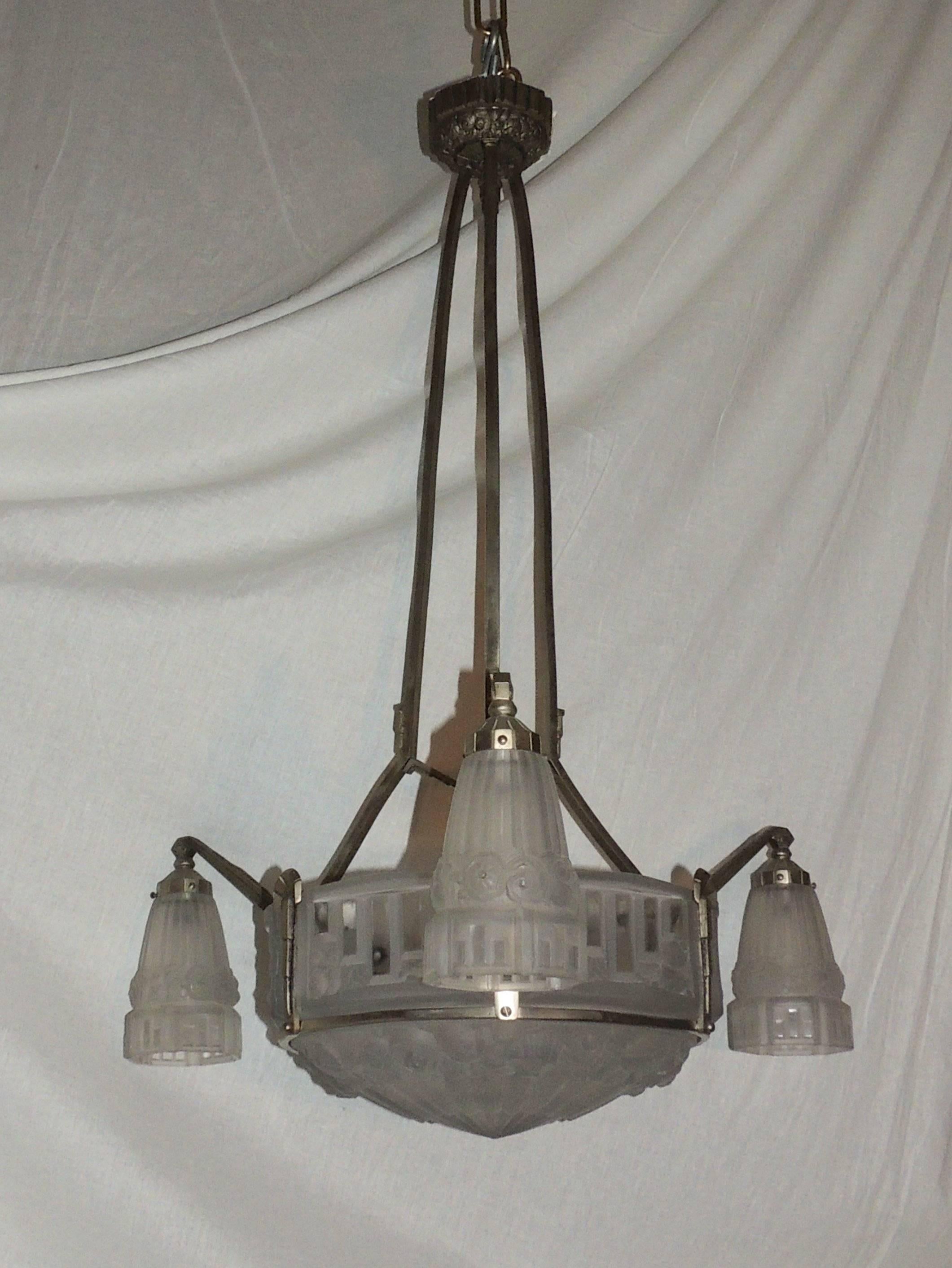 A large silvered bronze Art Deco chandelier with large Round centre and square shape panel frosted glass with a mix of graphics and roses around the band. There are three arms with matching shades and three interior lights in the