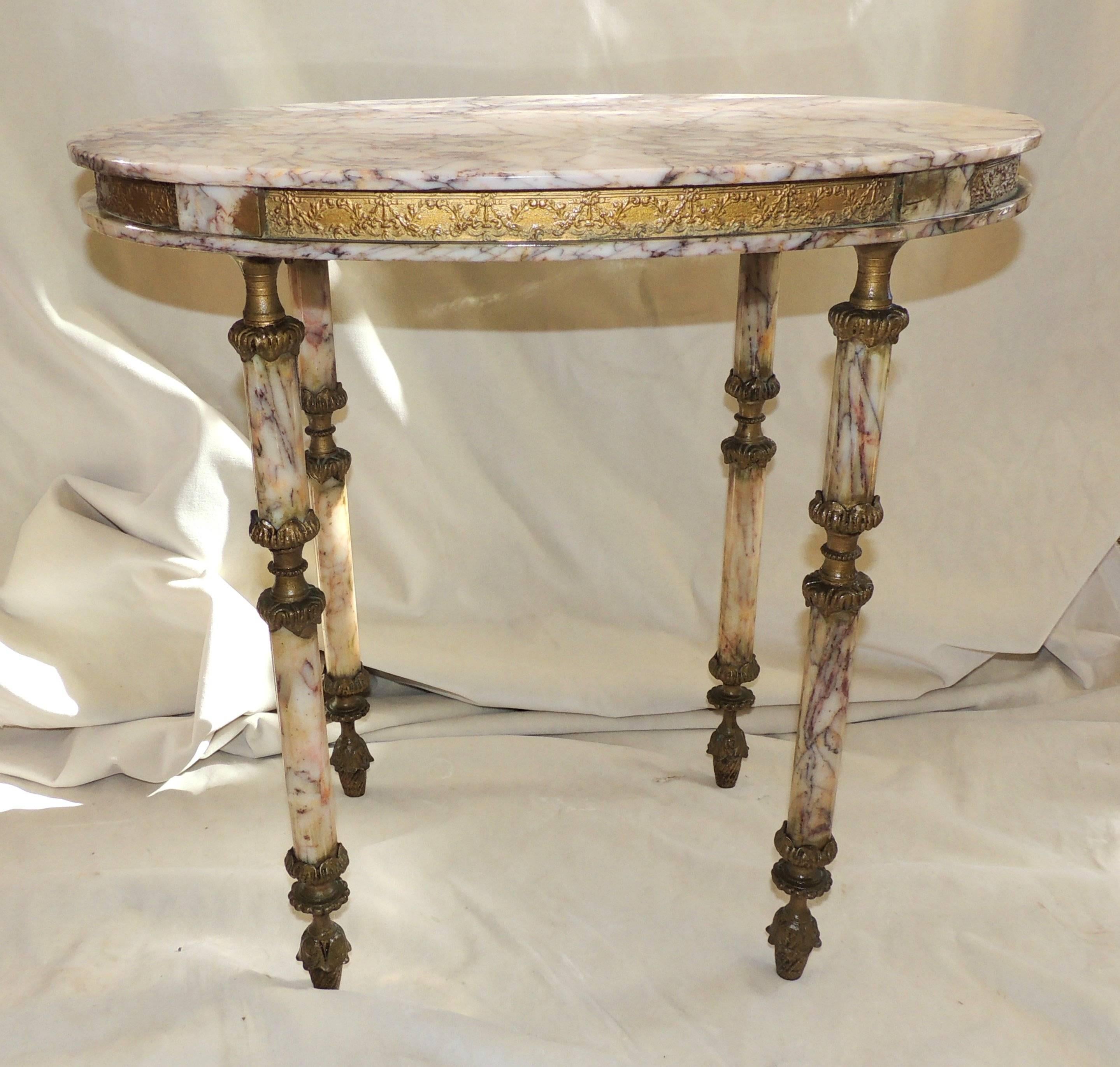 Beautiful marble-top and legs with doré bronze ormolu swag accents on the legs and along sides of the table.

Measures: 22.5" L x 16" W x 22.5" H.