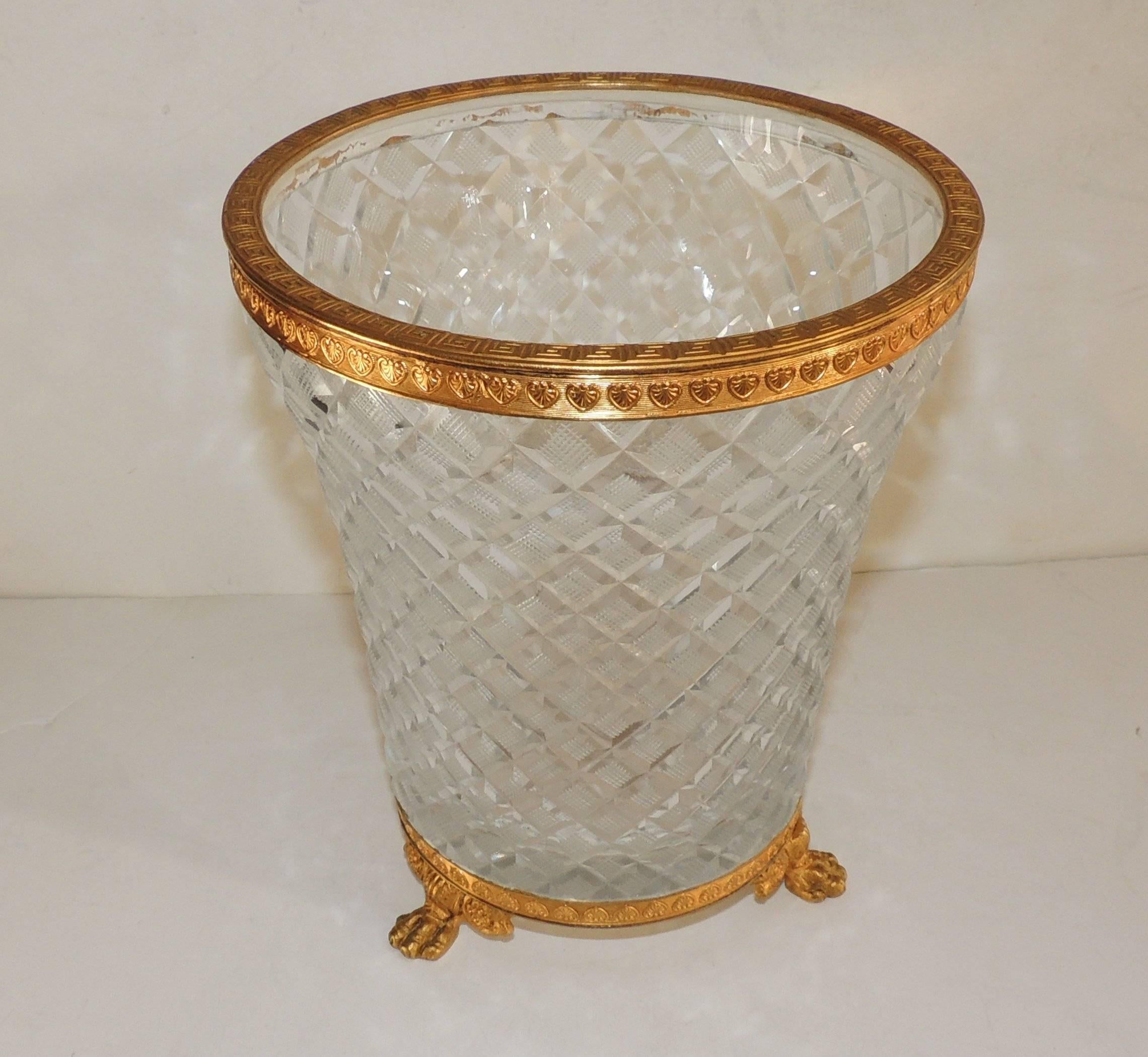 Wonderful French etched Greek key design and leaf design decorate the top and bottom of the doré bronze trim ending with 3 paw feet. Lovely etched diamond cut crystal ice bucket or can also be used as a vase.
In the manner of Baccarat 
Measures: