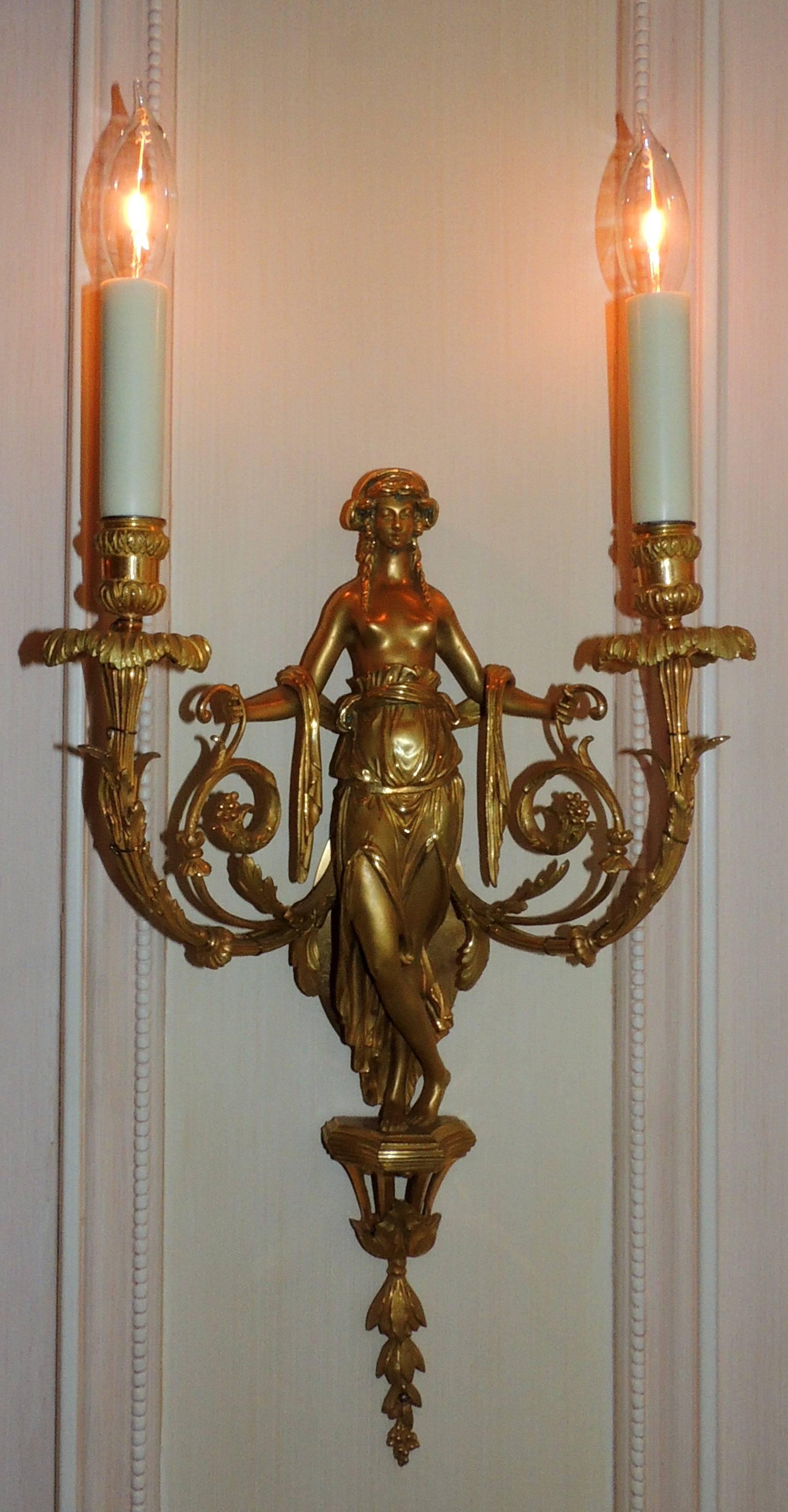 A wonderful pair of French doré bronze female/maiden sconces with floral garlands and swags in the regency decor attributed to Francois Linke.