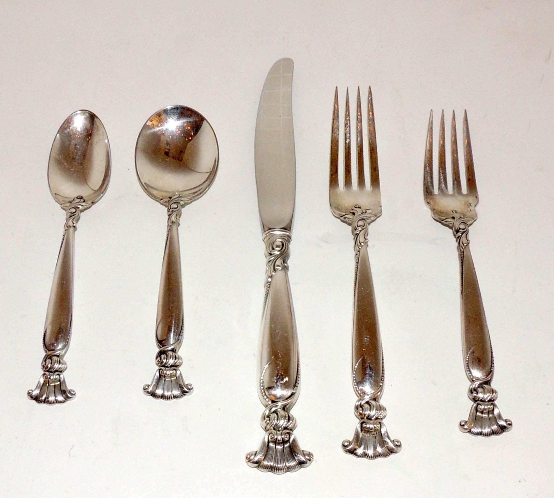A wonderful Wallace sterling silver flatware service for 12 Romance of The Sea Pattern 63 pieces total, set consisting of:
9