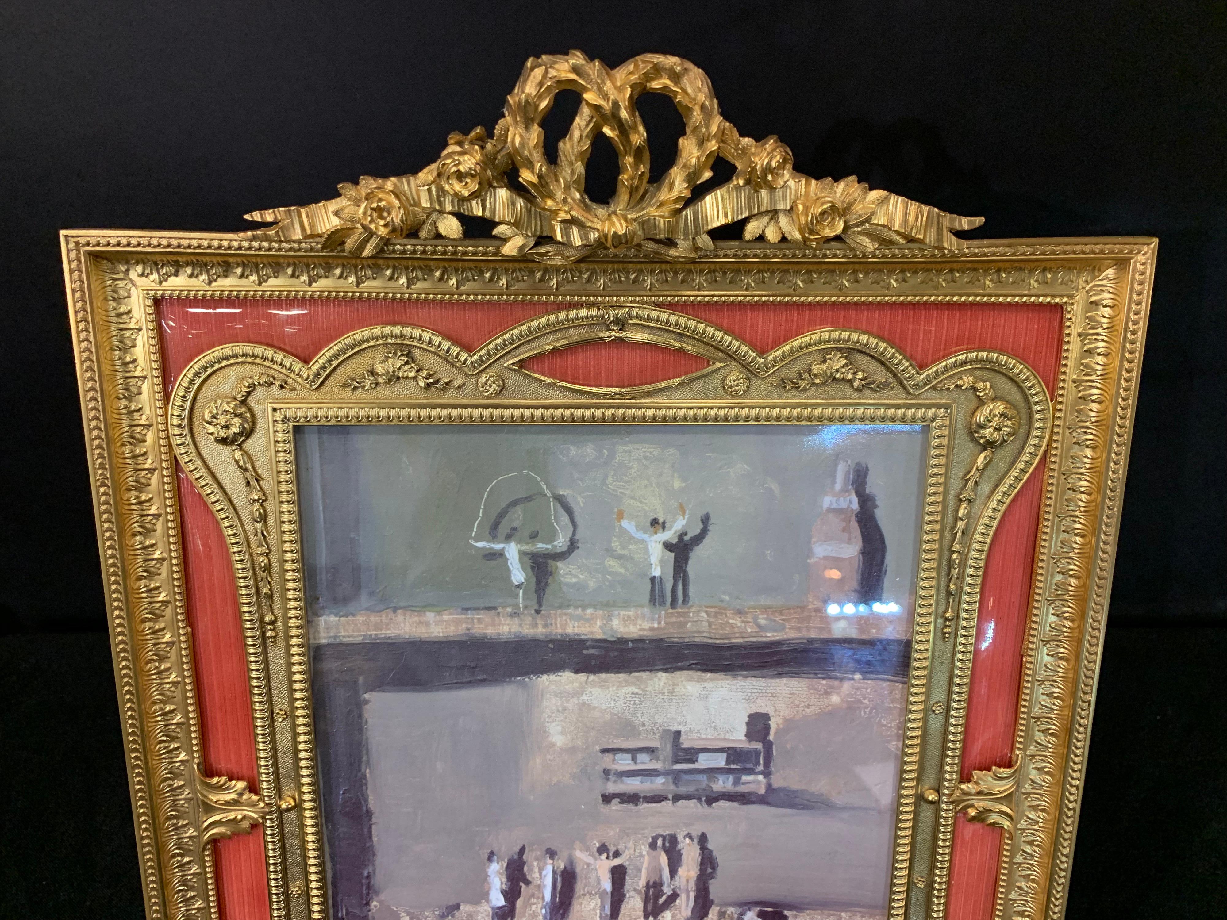 A wonderful French gilt bronze and salmon / pink enamel bow top picture frame.